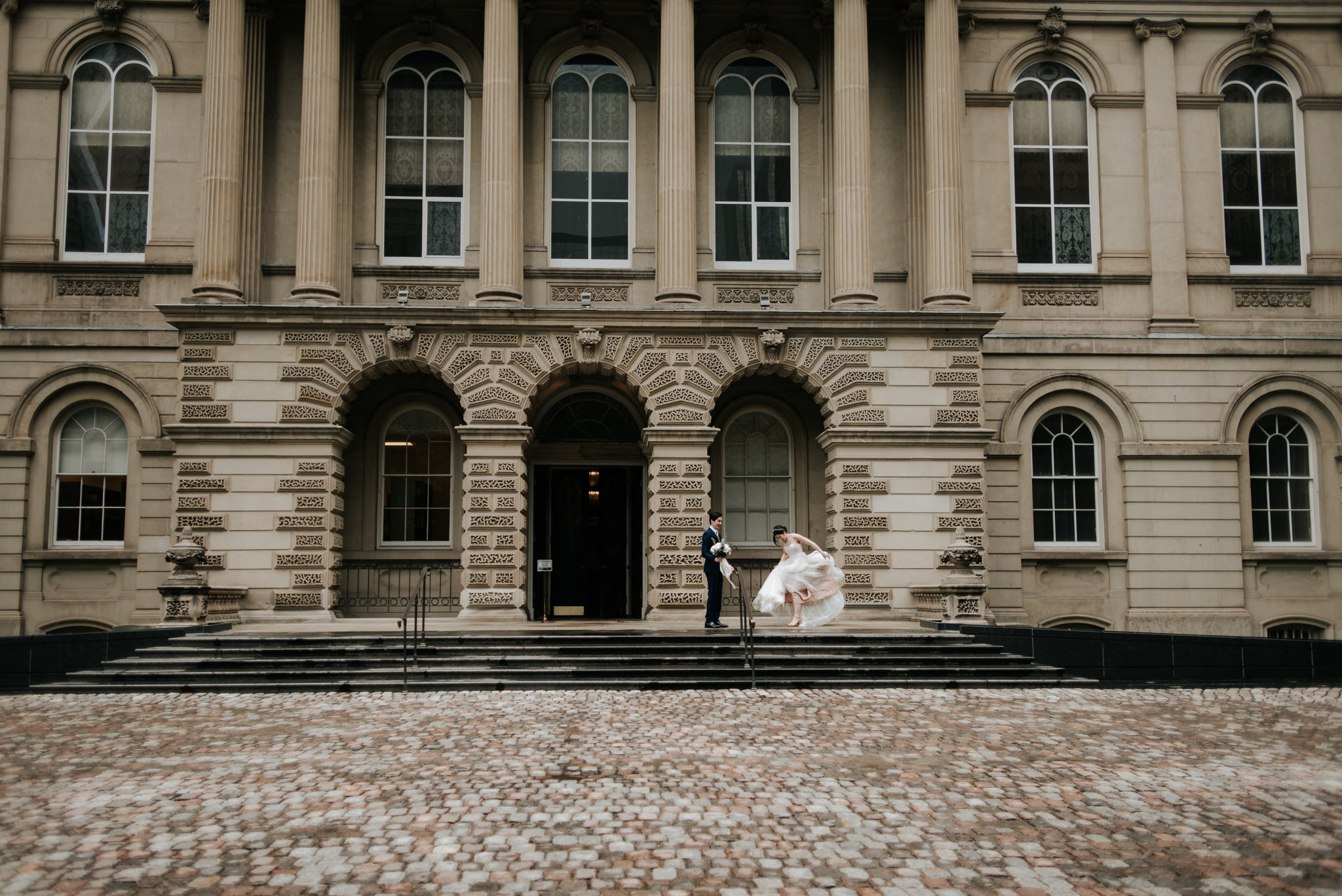 couple on wedding day in front of Osgoode Hall in Toronto