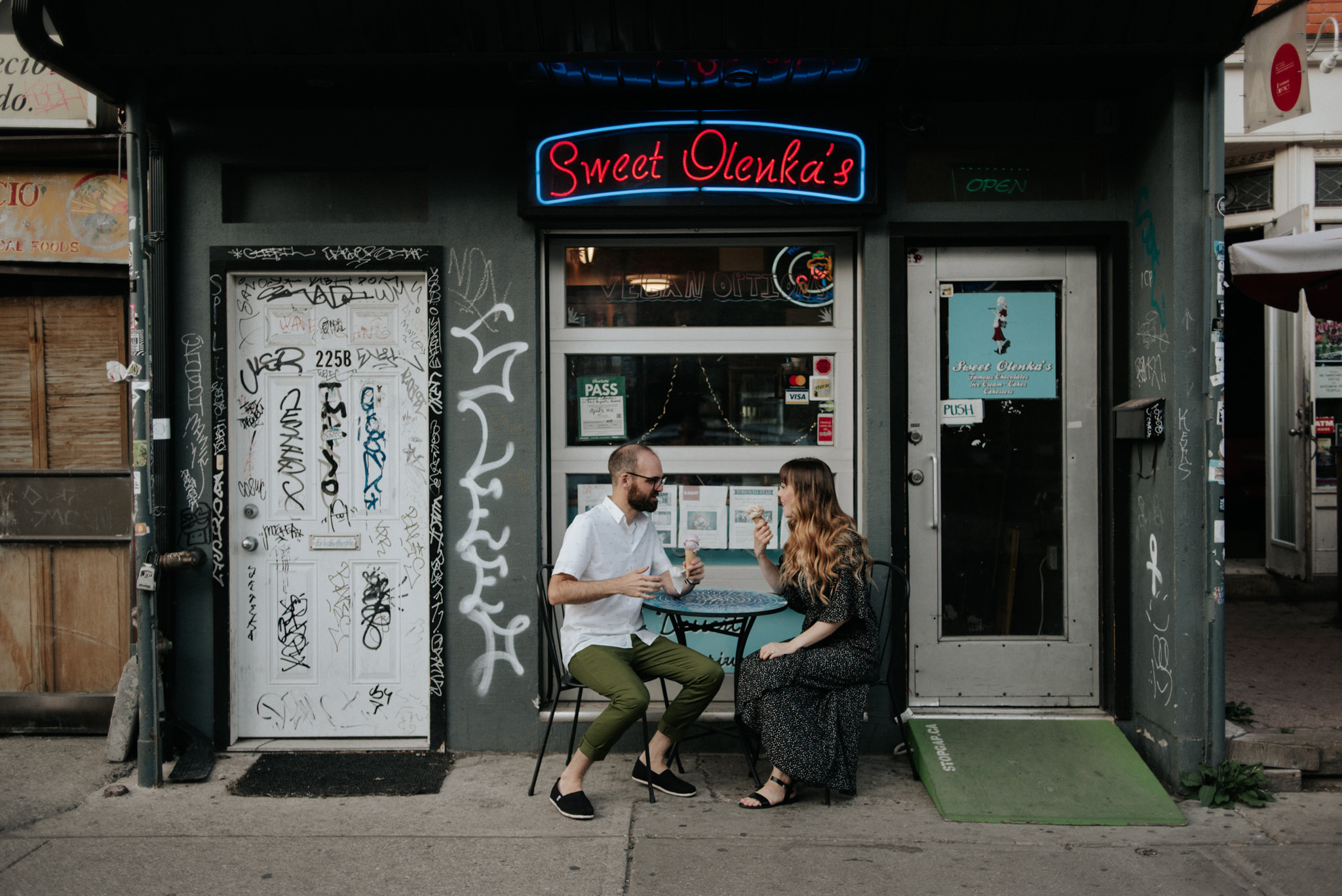 Couple eating ice cream in front of Sweet Olenkas in Kensington Market Engagement Shoot