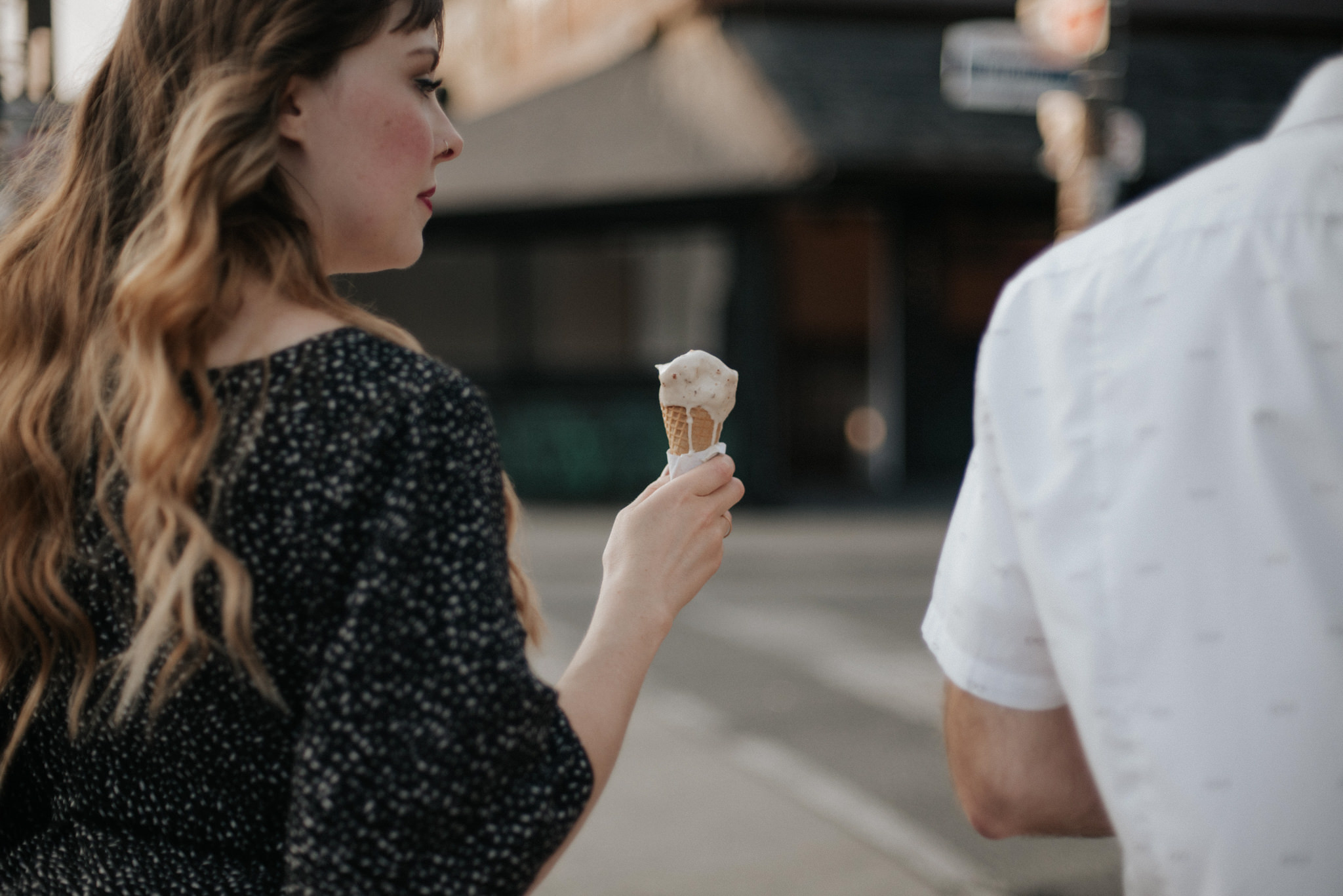 Girl holding ice cream cone walking in Kensington market