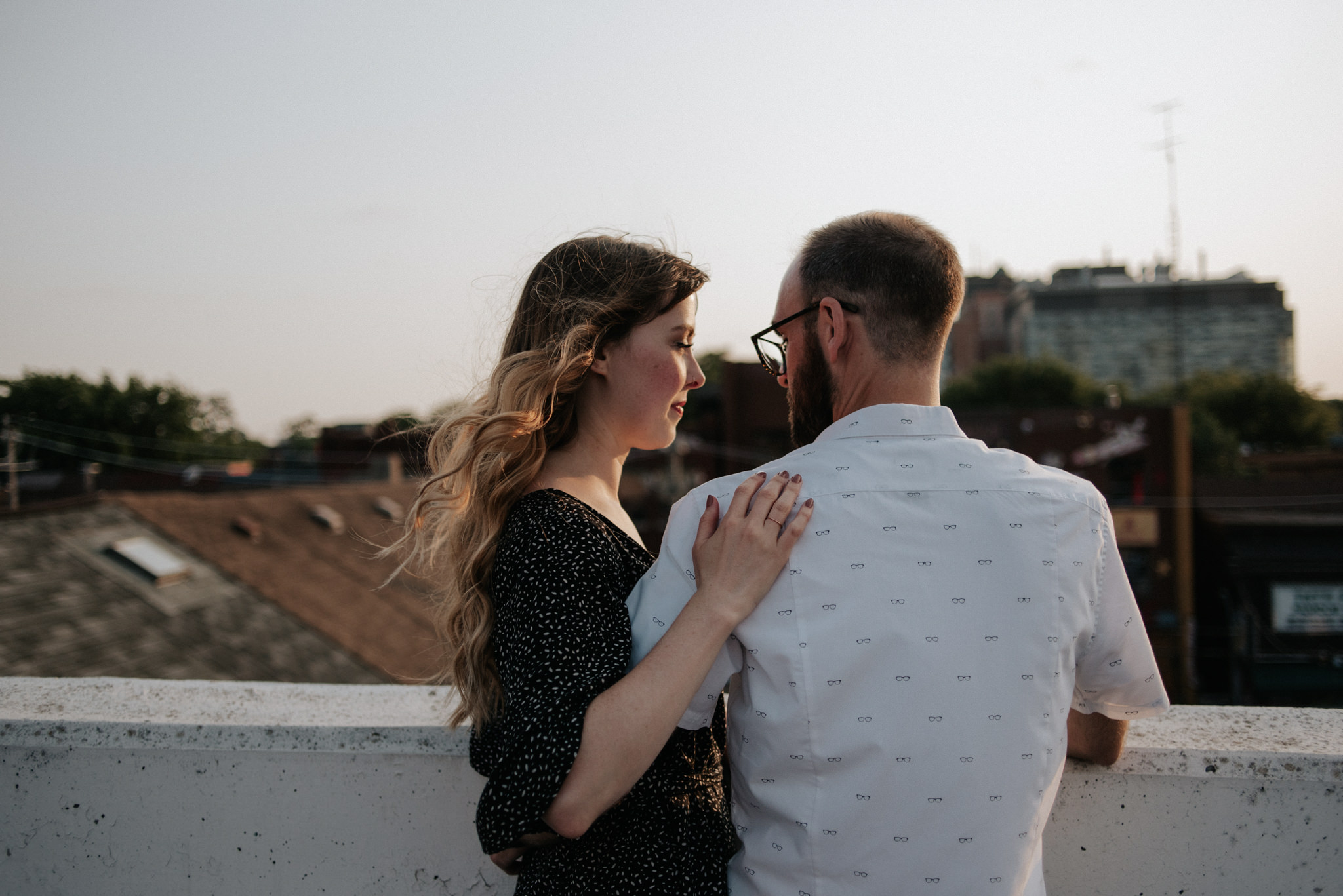 Couple standing on rooftop in Toronto at sunset