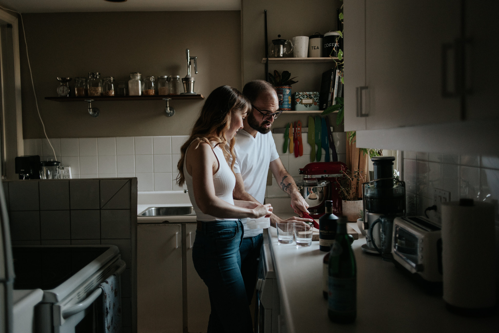 couple in their apartment making drinks