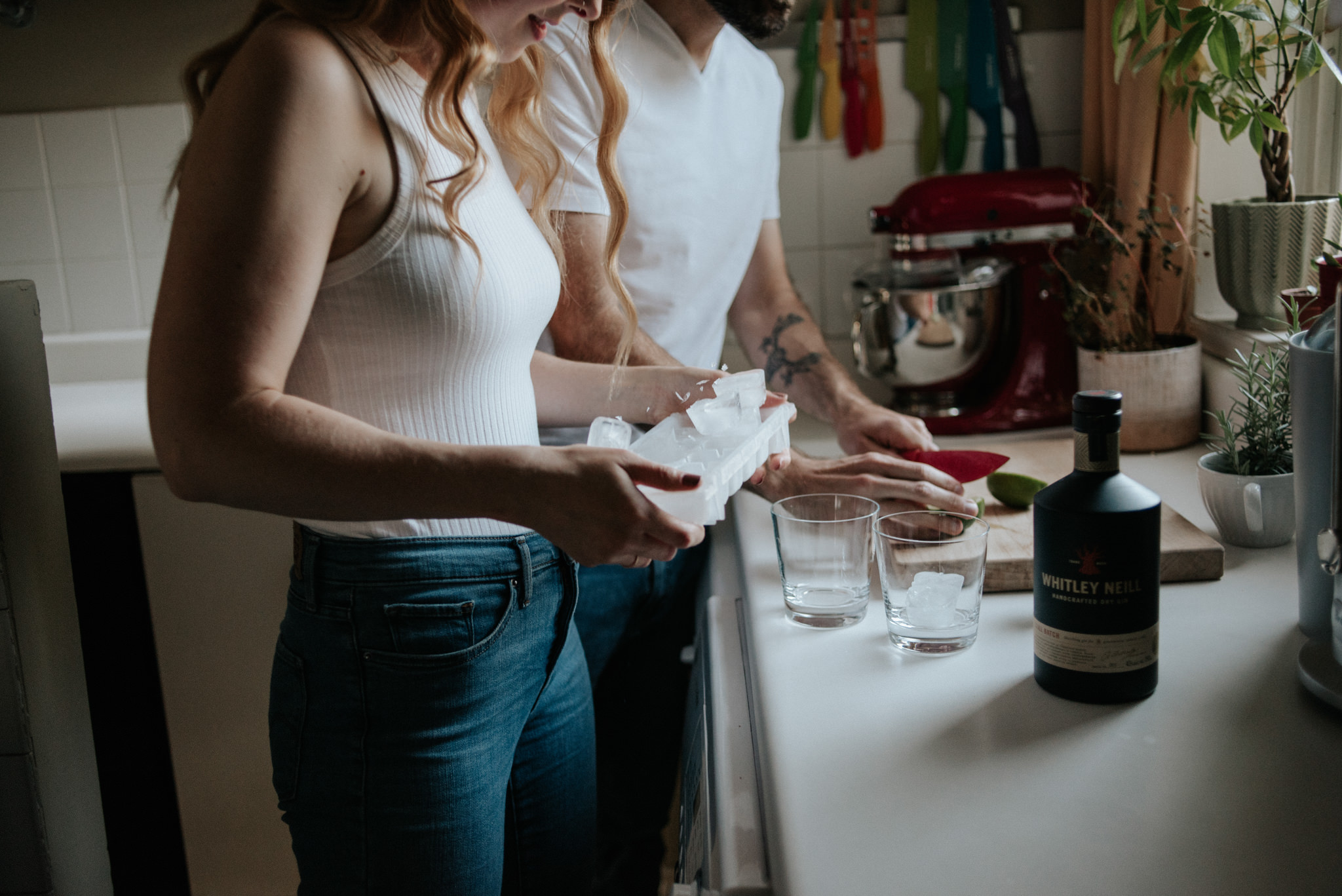 couple in their apartment making drinks