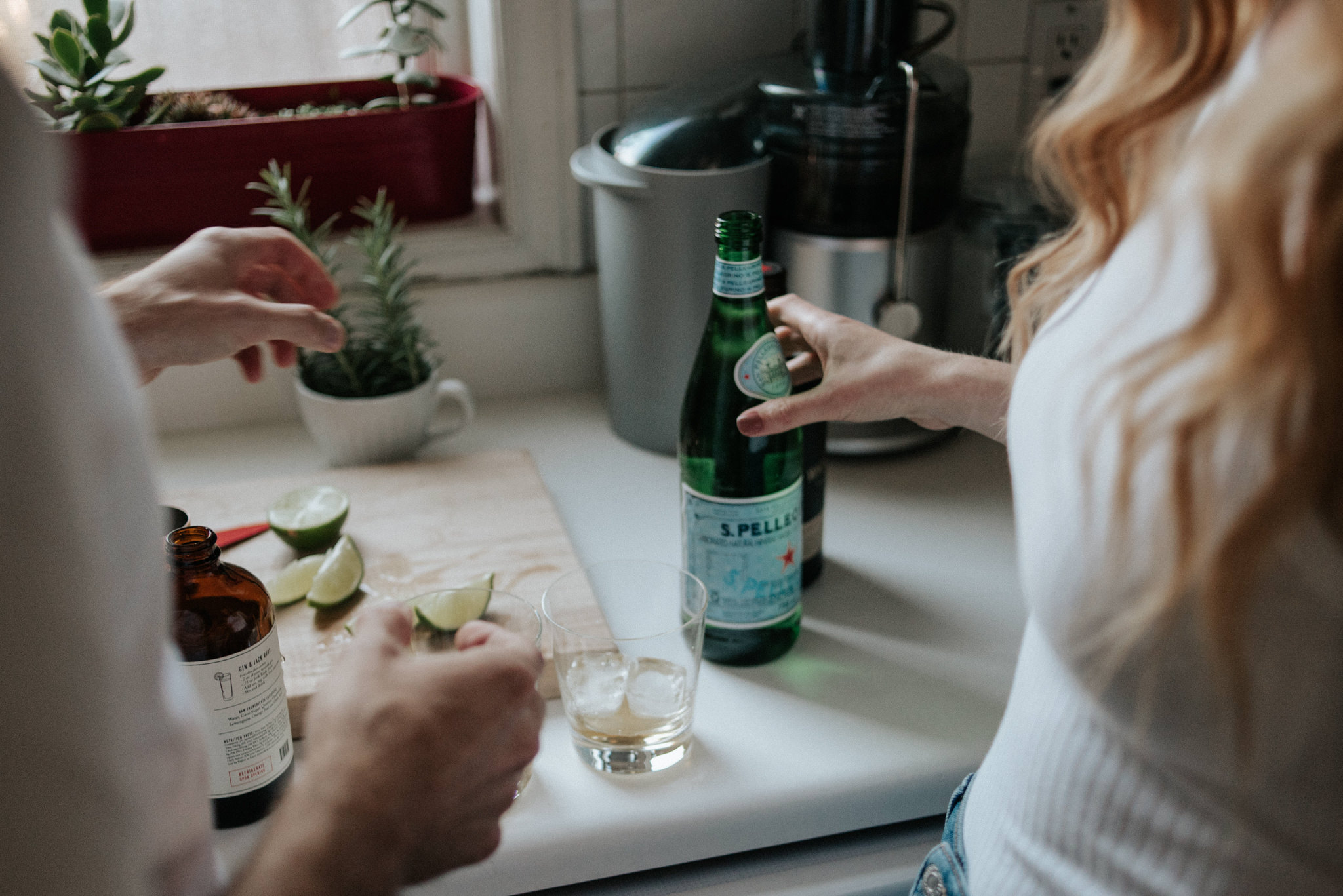 couple in their apartment making drinks