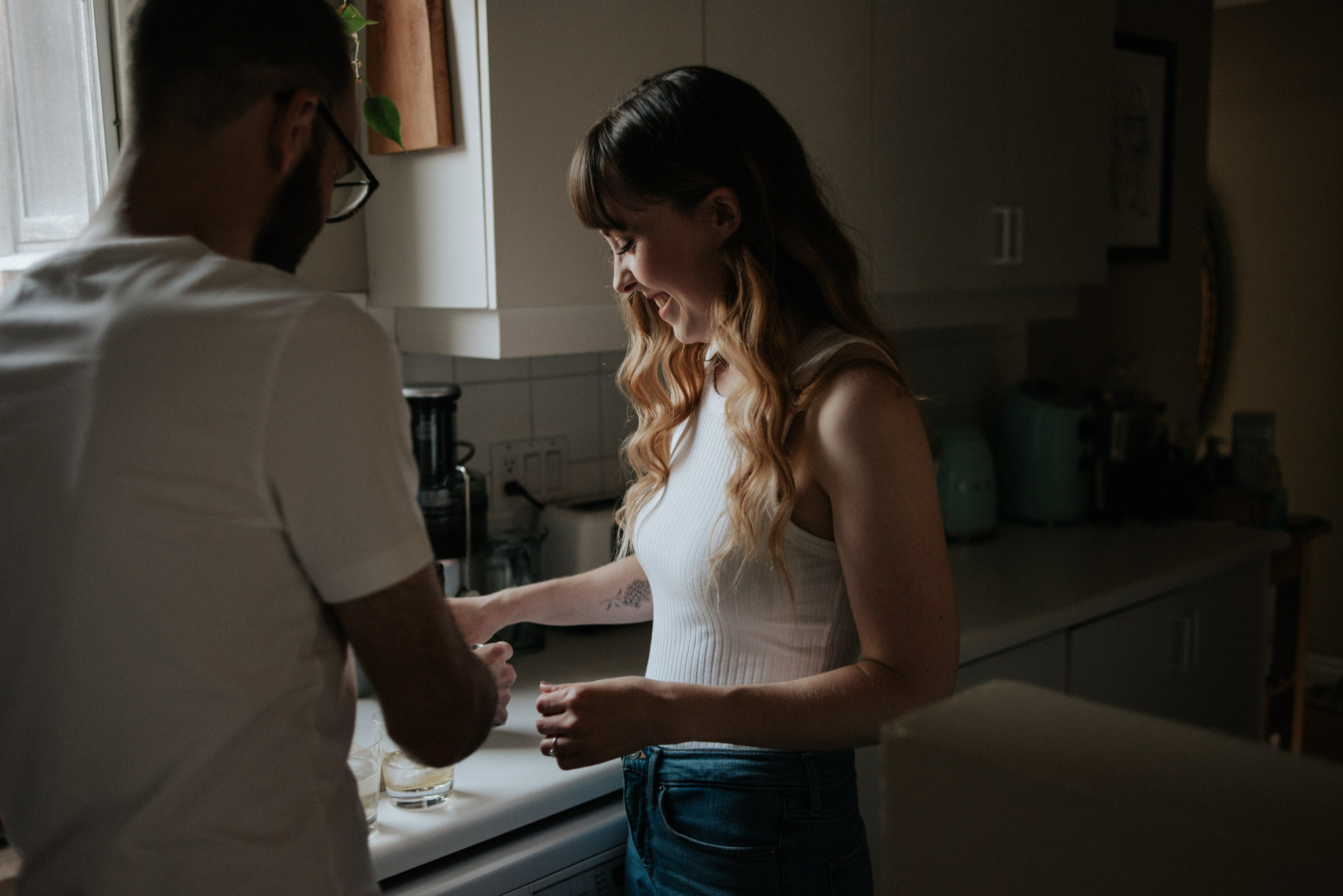 couple in their apartment making drinks