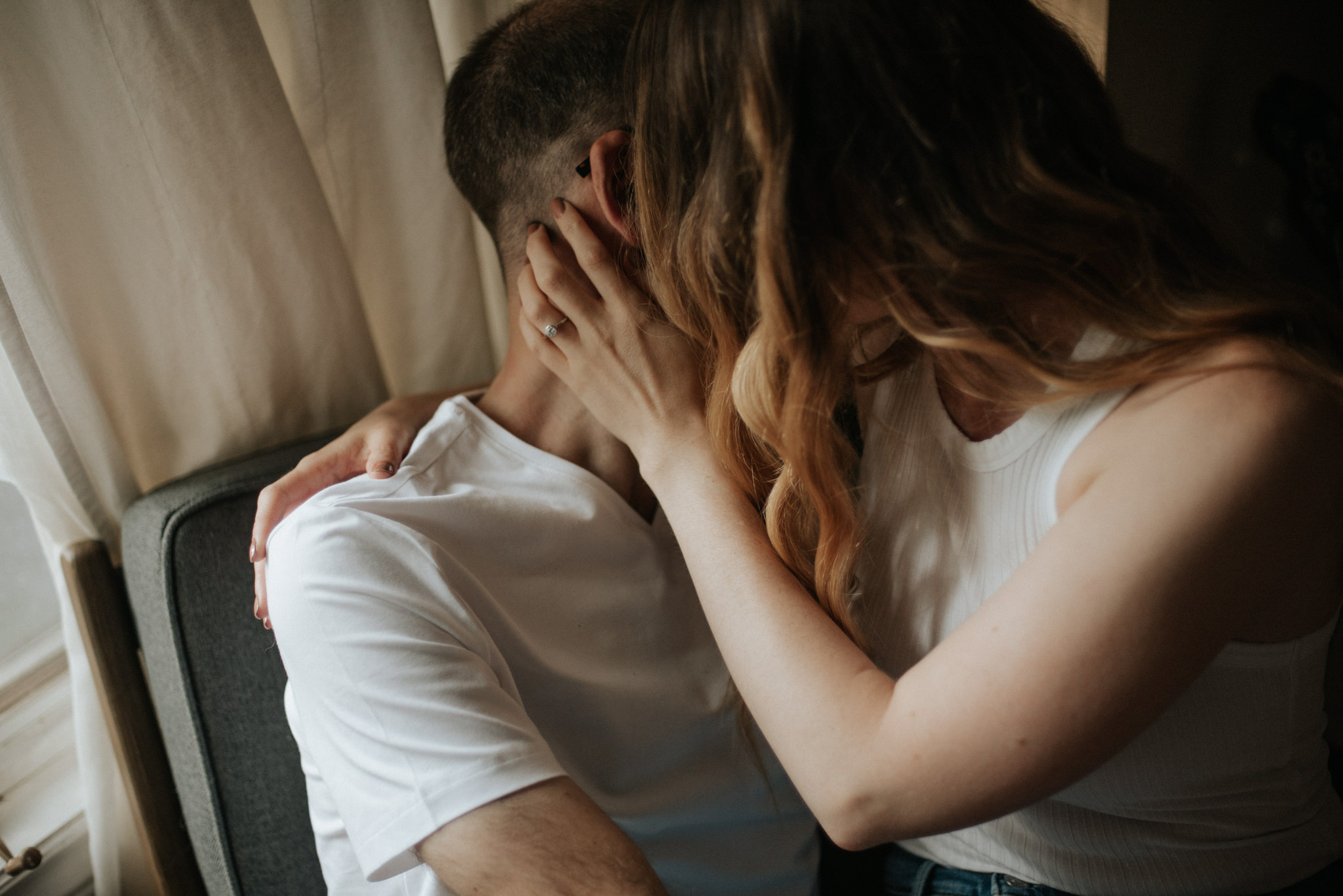 Girl sitting on guy's lap on chair