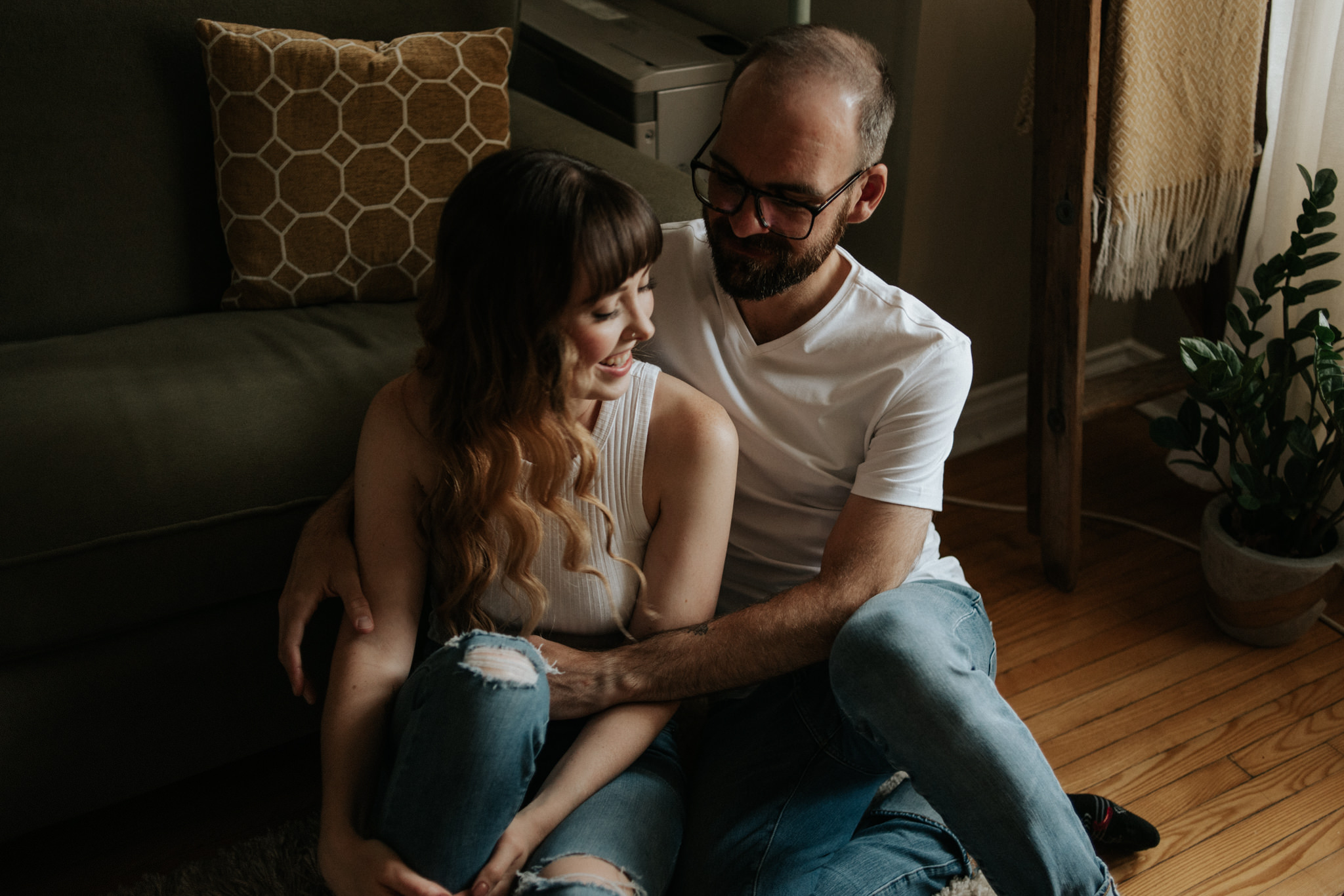 Couple cuddling on apartment floor