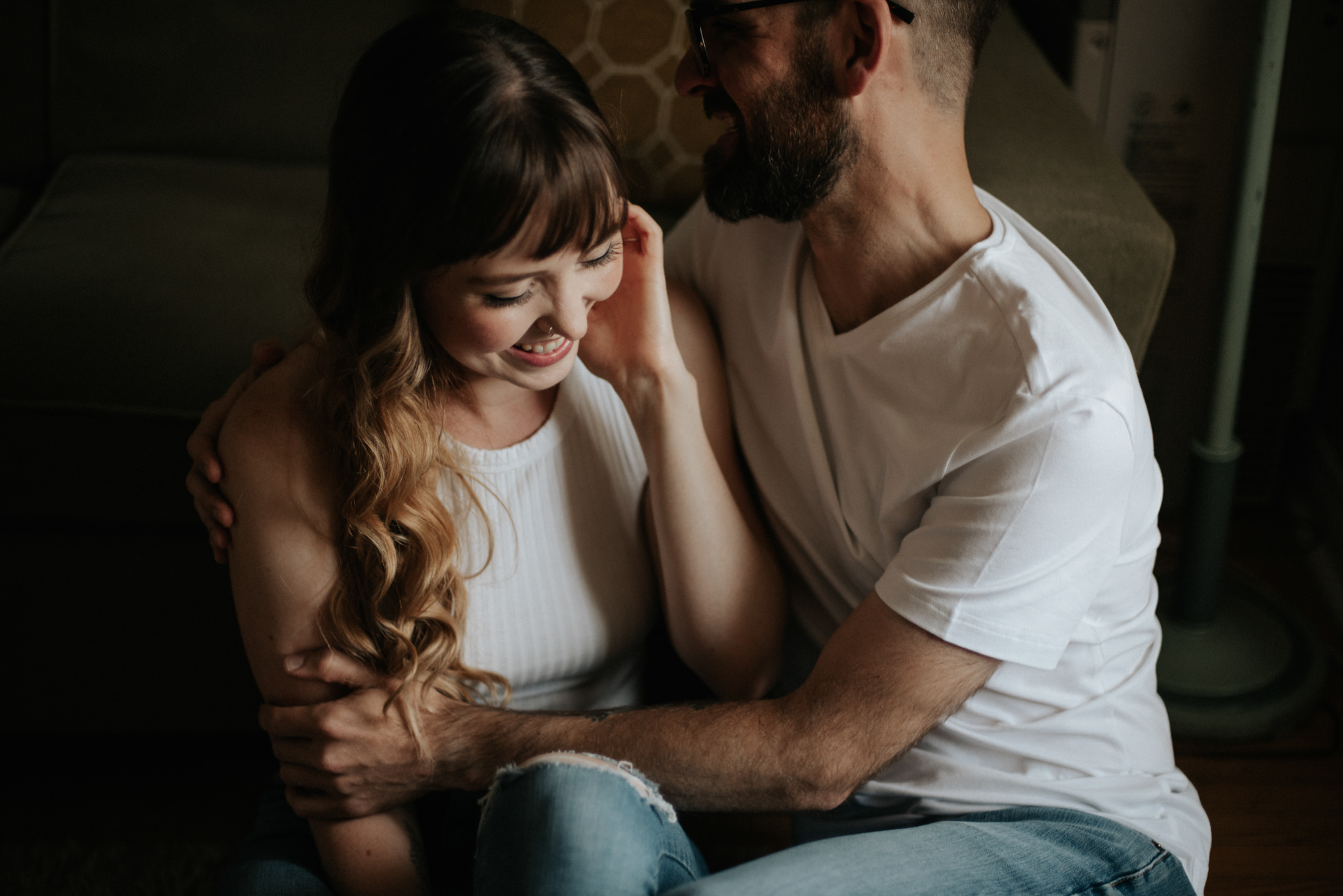 Couple cuddling on apartment floor