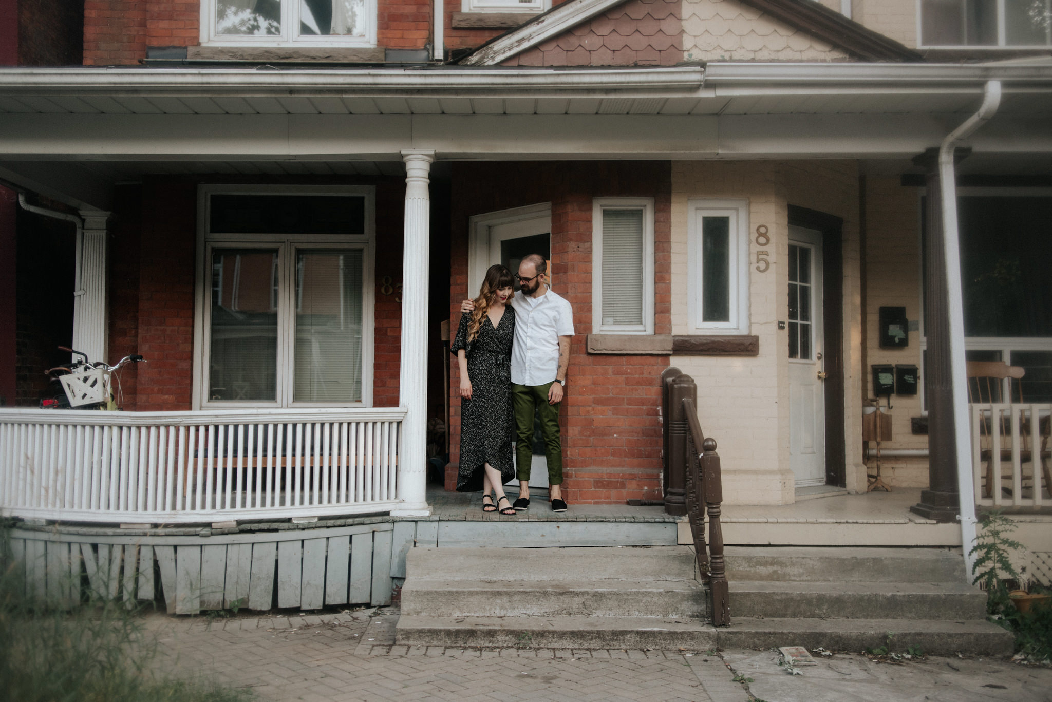 Couple standing in front of their home in Toronto