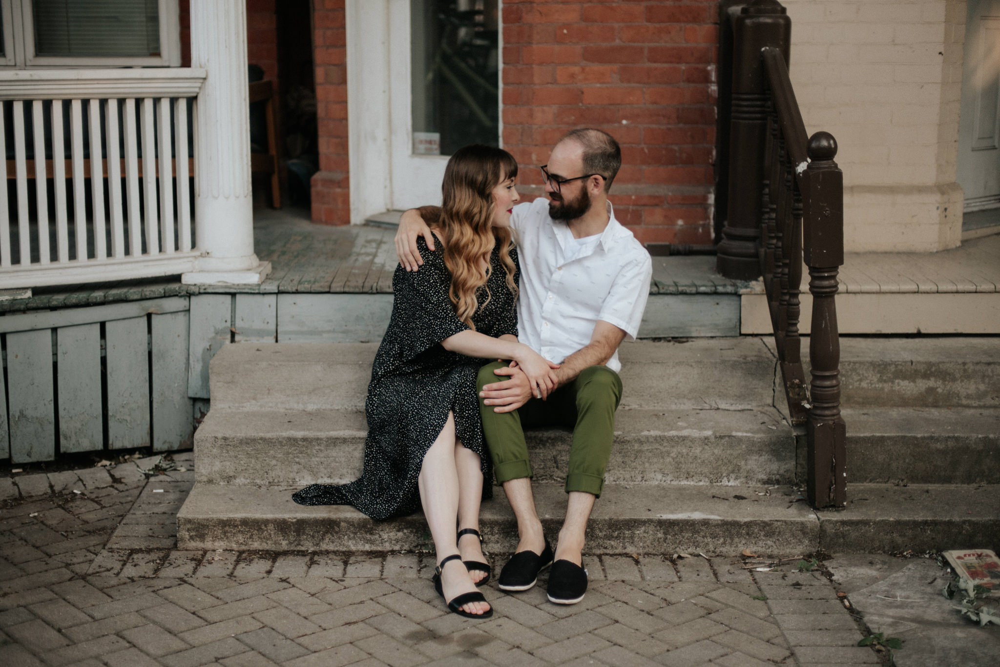 Couple sitting on front porch steps