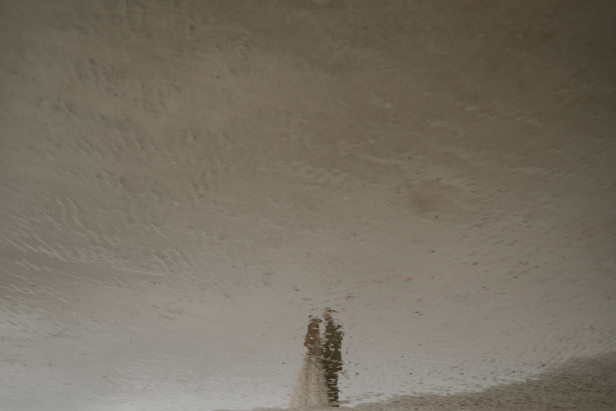 wet sand reflection of couple for Tofino elopement on Chesterman Beach