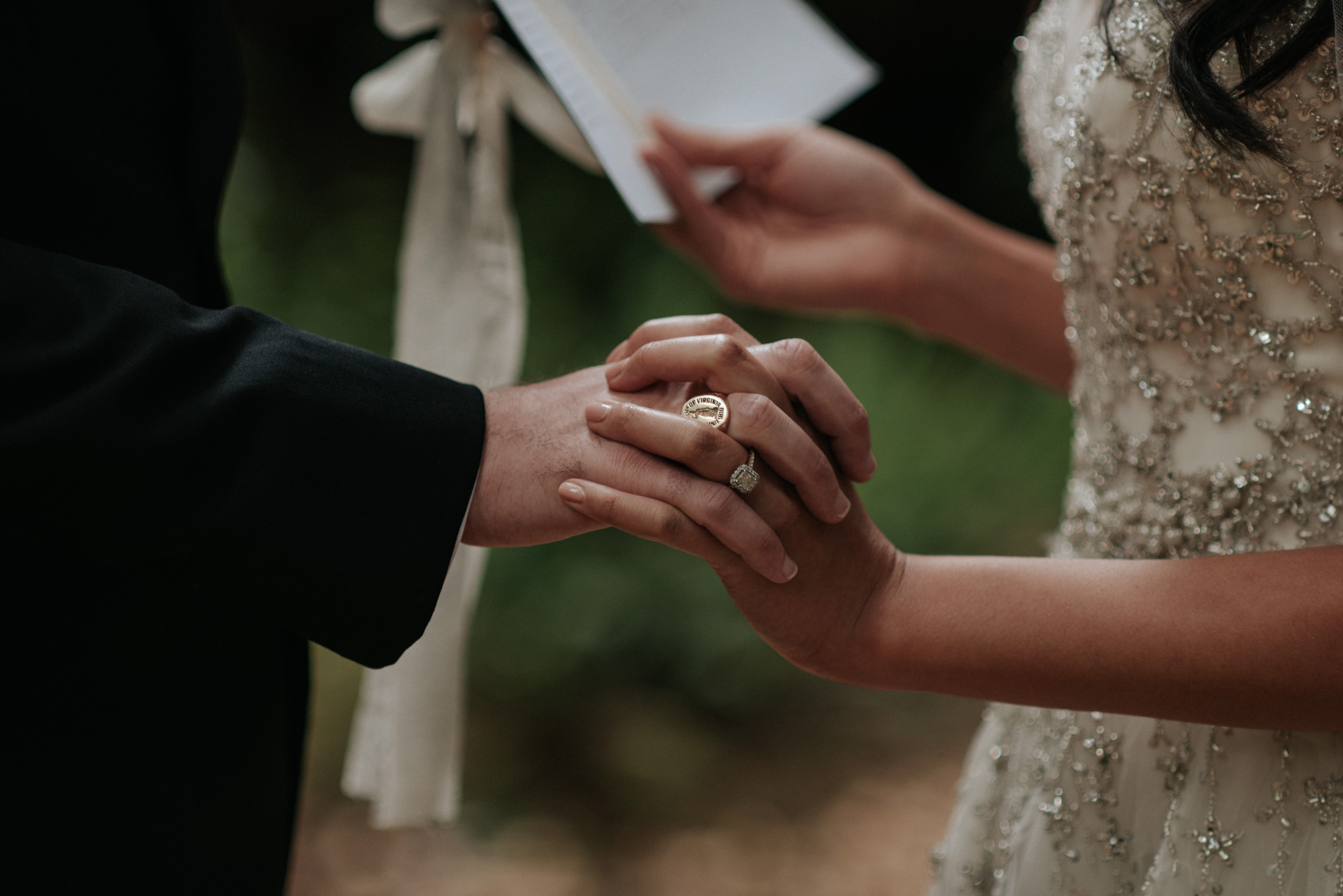 couple holding hands and reading vows to each other