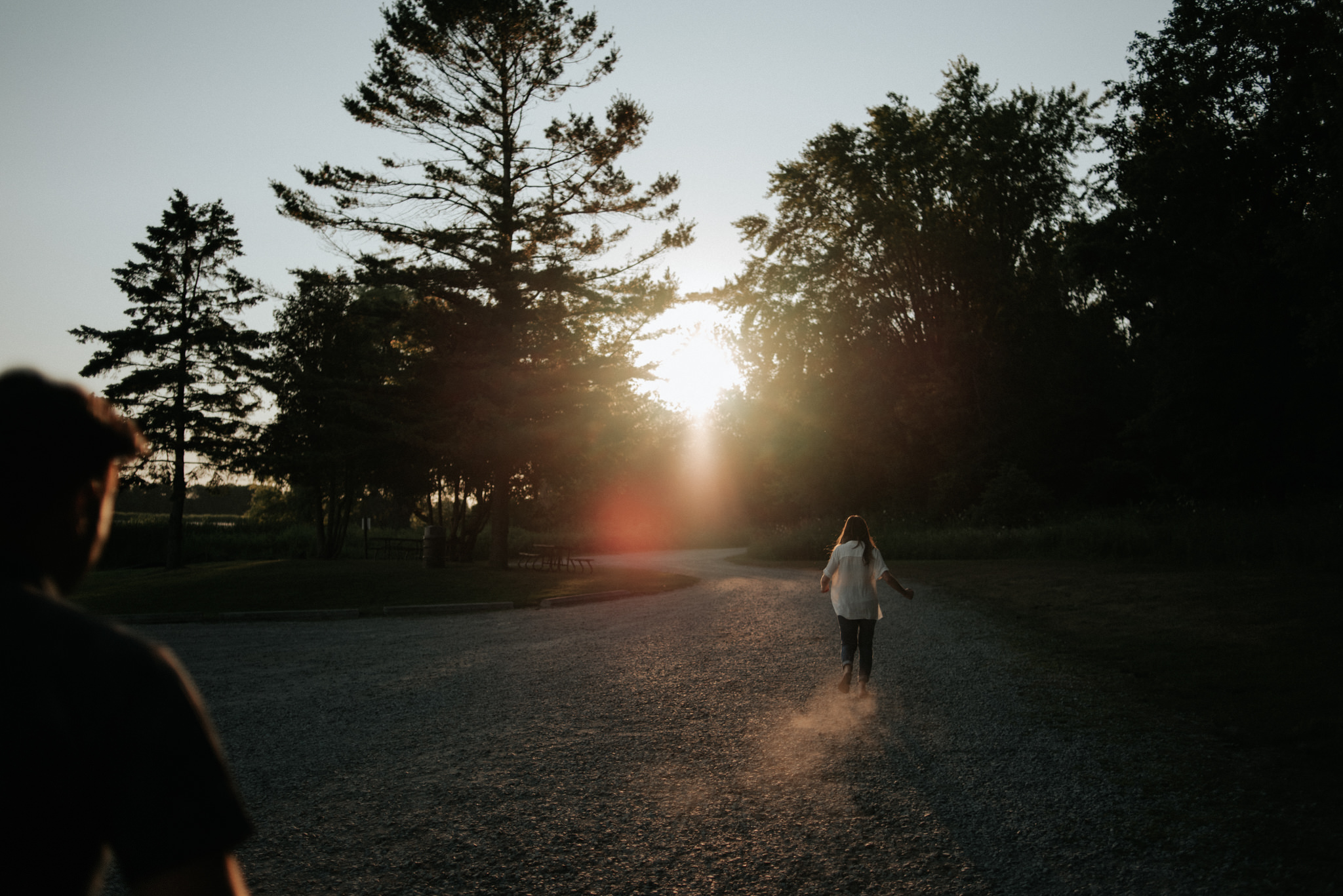 couple on dusty road at sunset