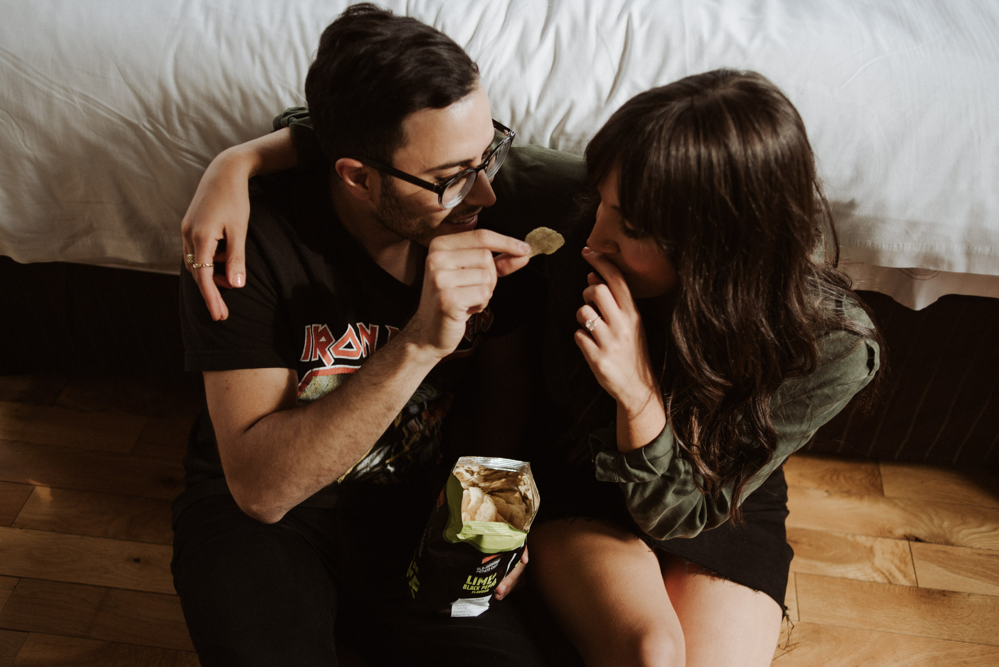 couple sitting on floor eating chips at Gladstone Hotel