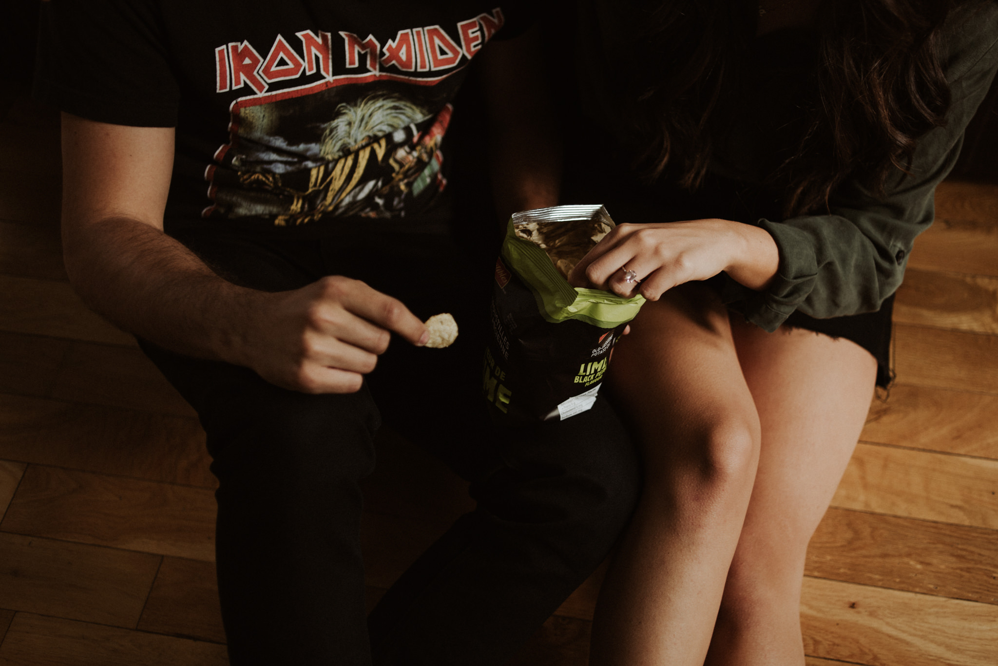 couple sitting on floor eating chips at Gladstone Hotel