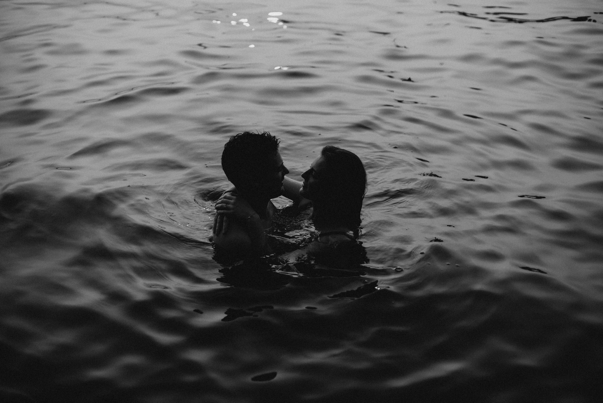 Couple in water at sunset