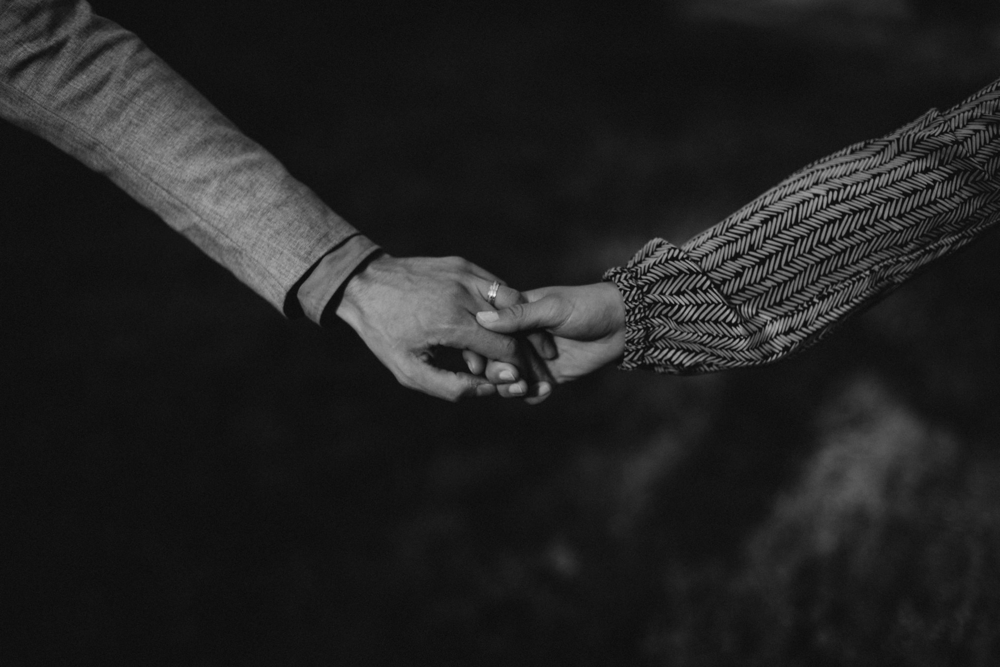 black and white image of couple holding hands