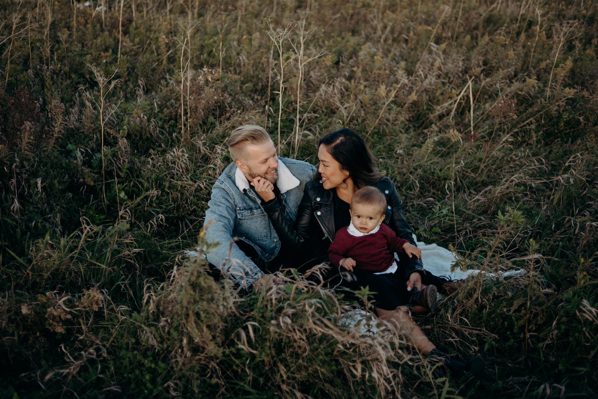 young hip couple sitting in grass