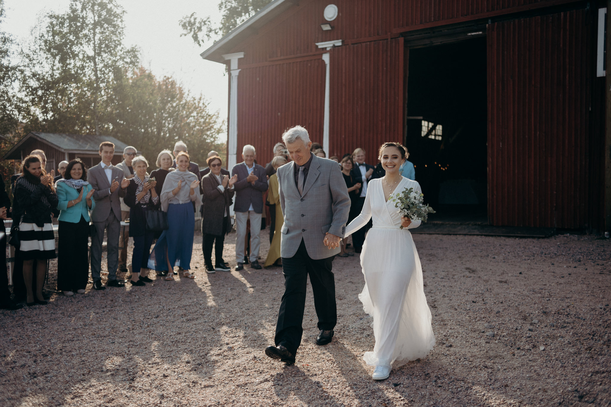 Black and white images of bride putting on grooms ring during wedding ceremony