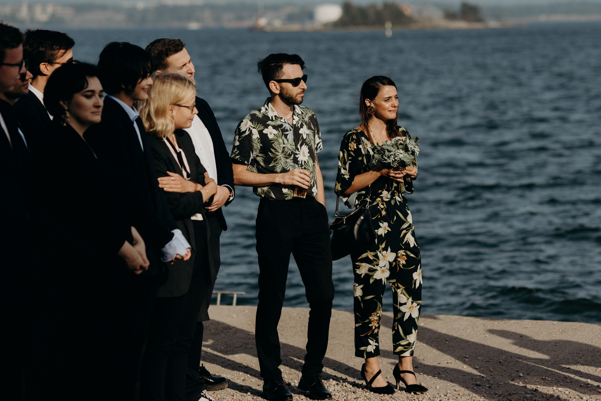 Guests cheering and clapping during outdoor wedding ceremony at Valkosaaren Telakka