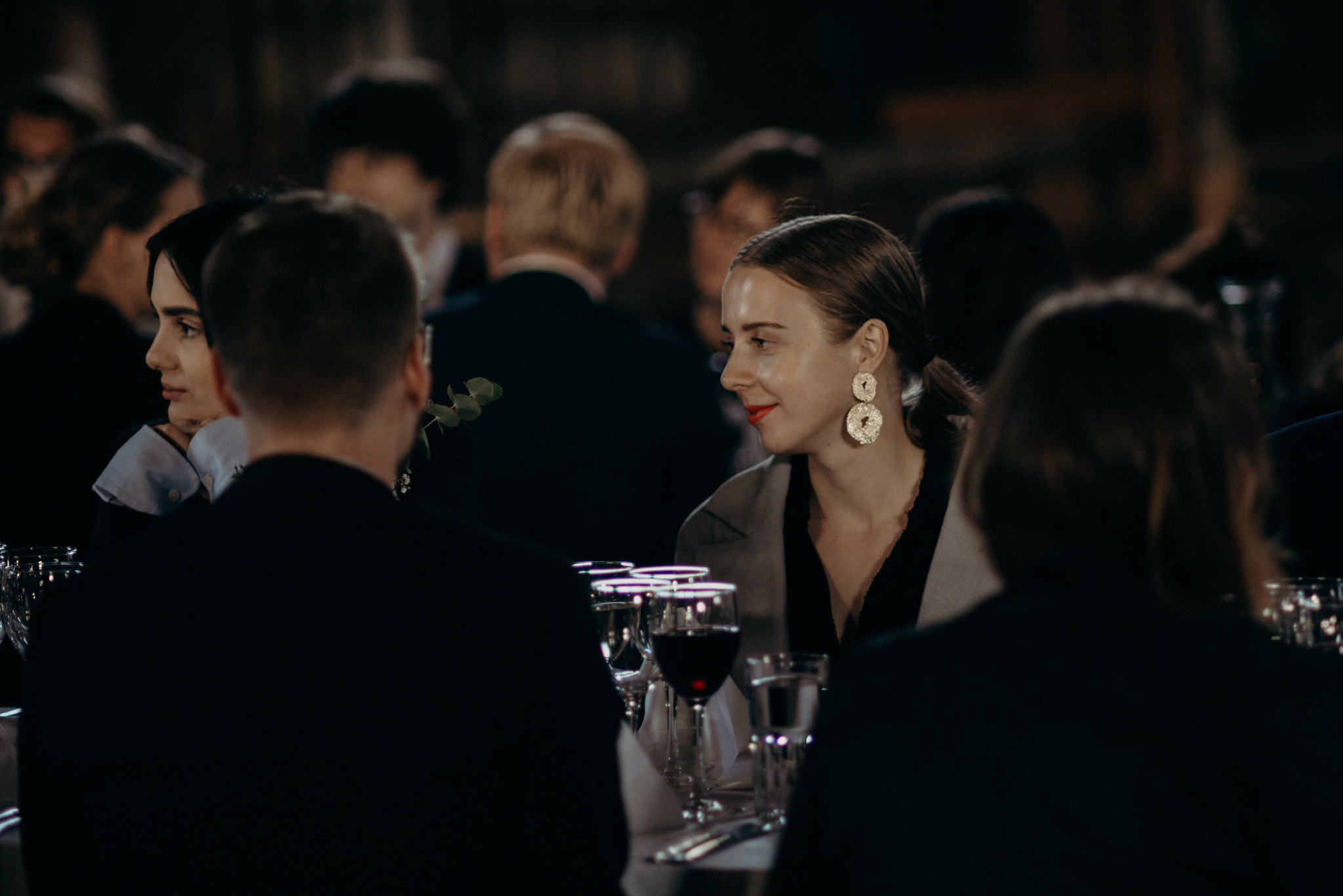 Guests listening during speeches at Valkosaaren Telakka wedding reception