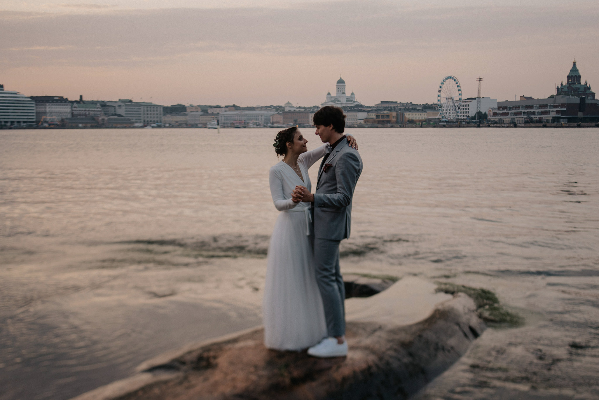 Wedding portraits overlooking Helsinki from Valkosaari at sunset
