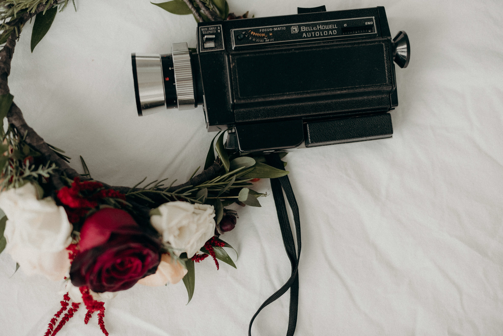 bouquet and shoes on bed