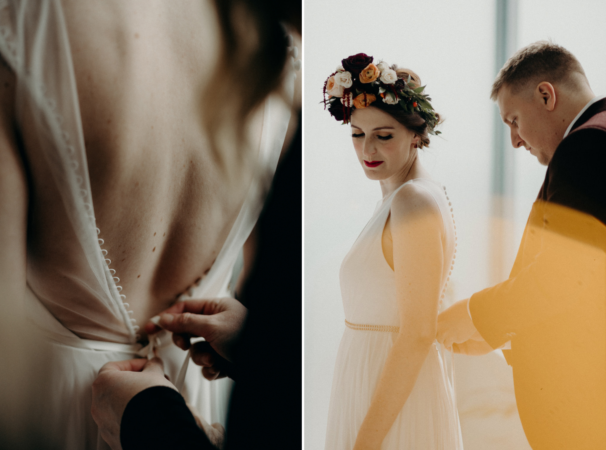 groom doing up back of brides dress in front of large windows in bedroom