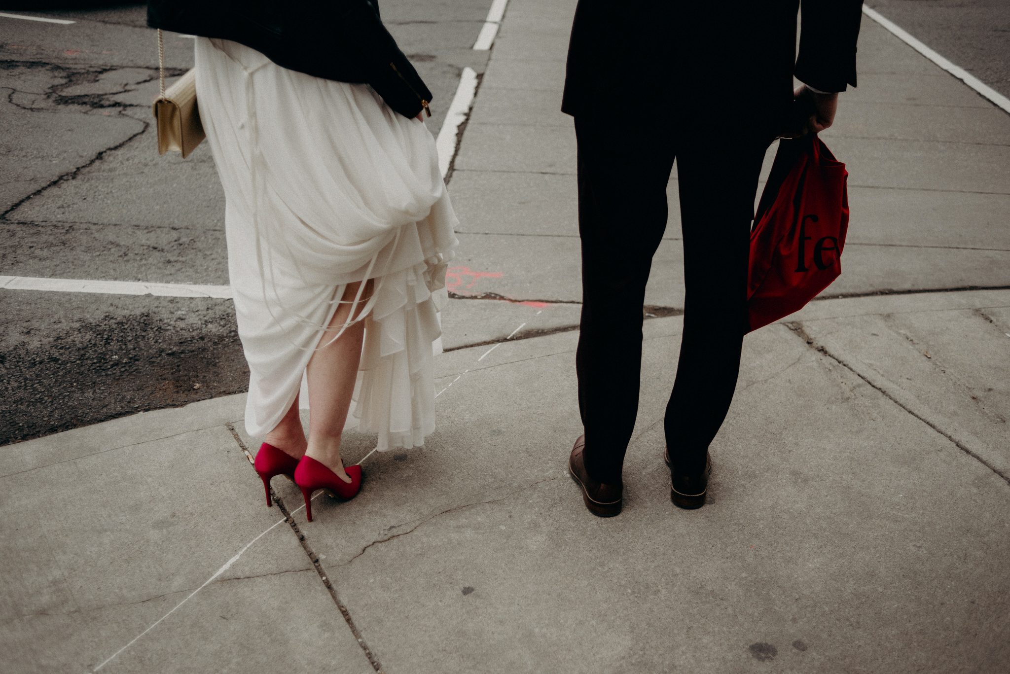 bride wiping grooms nose with tissue on patio