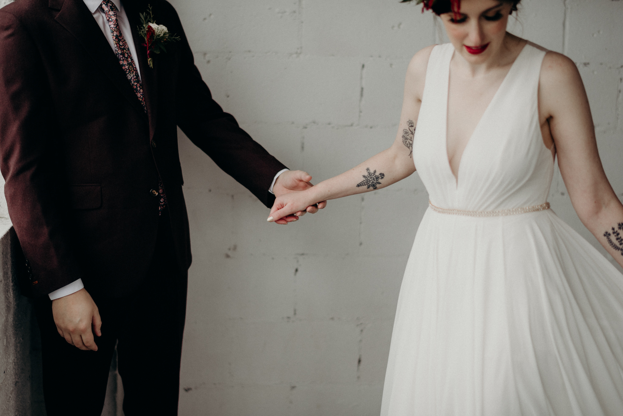 bride and groom standing in front of old windows of loft, black and white images