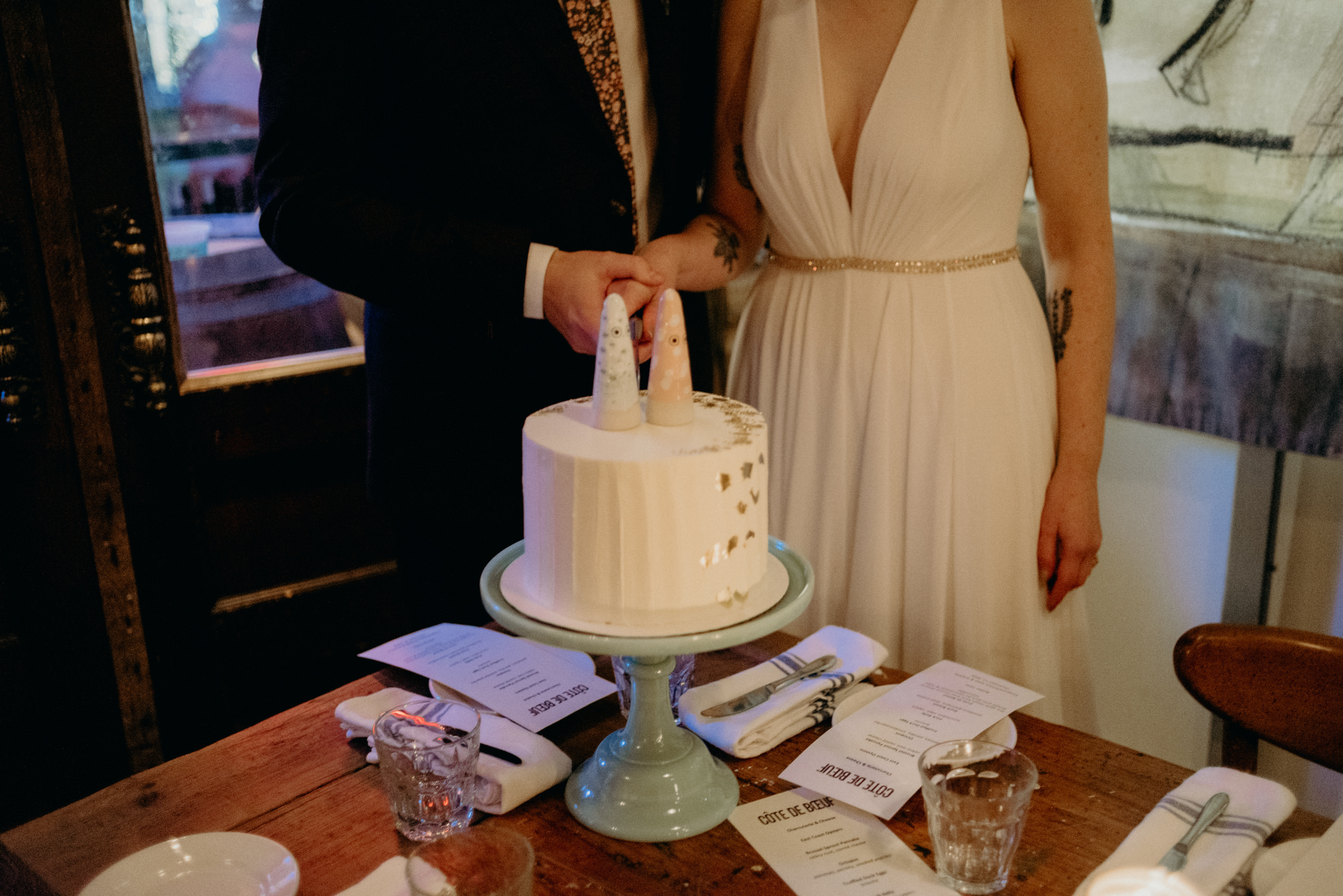 bride and groom cutting cake in restaurant, Cote de Boeuf wedding reception