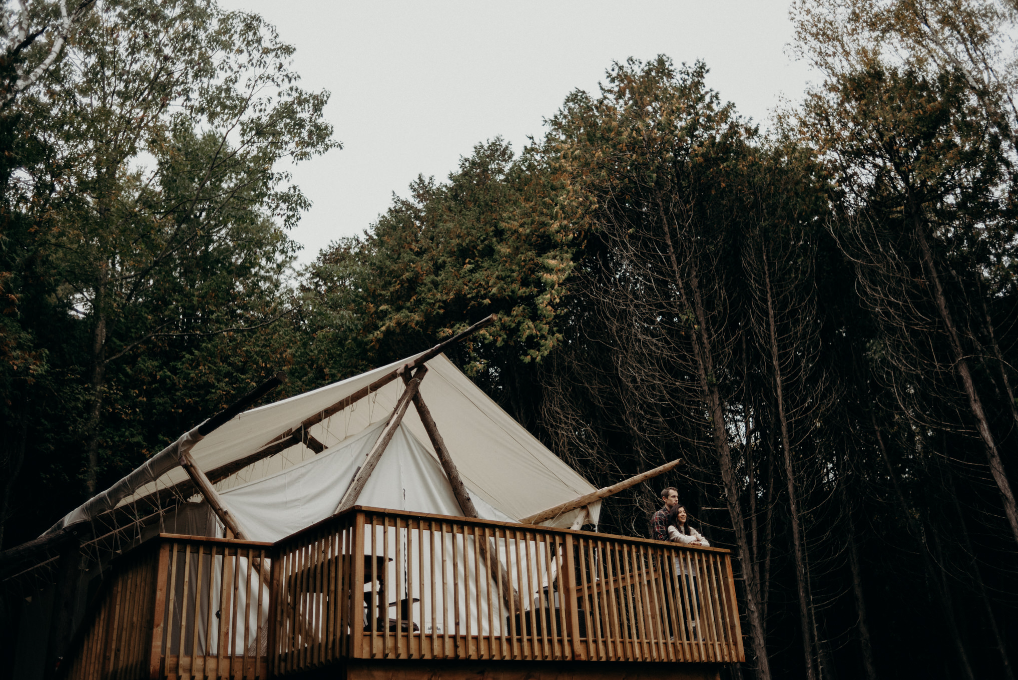 couple standing in front of glamping tent