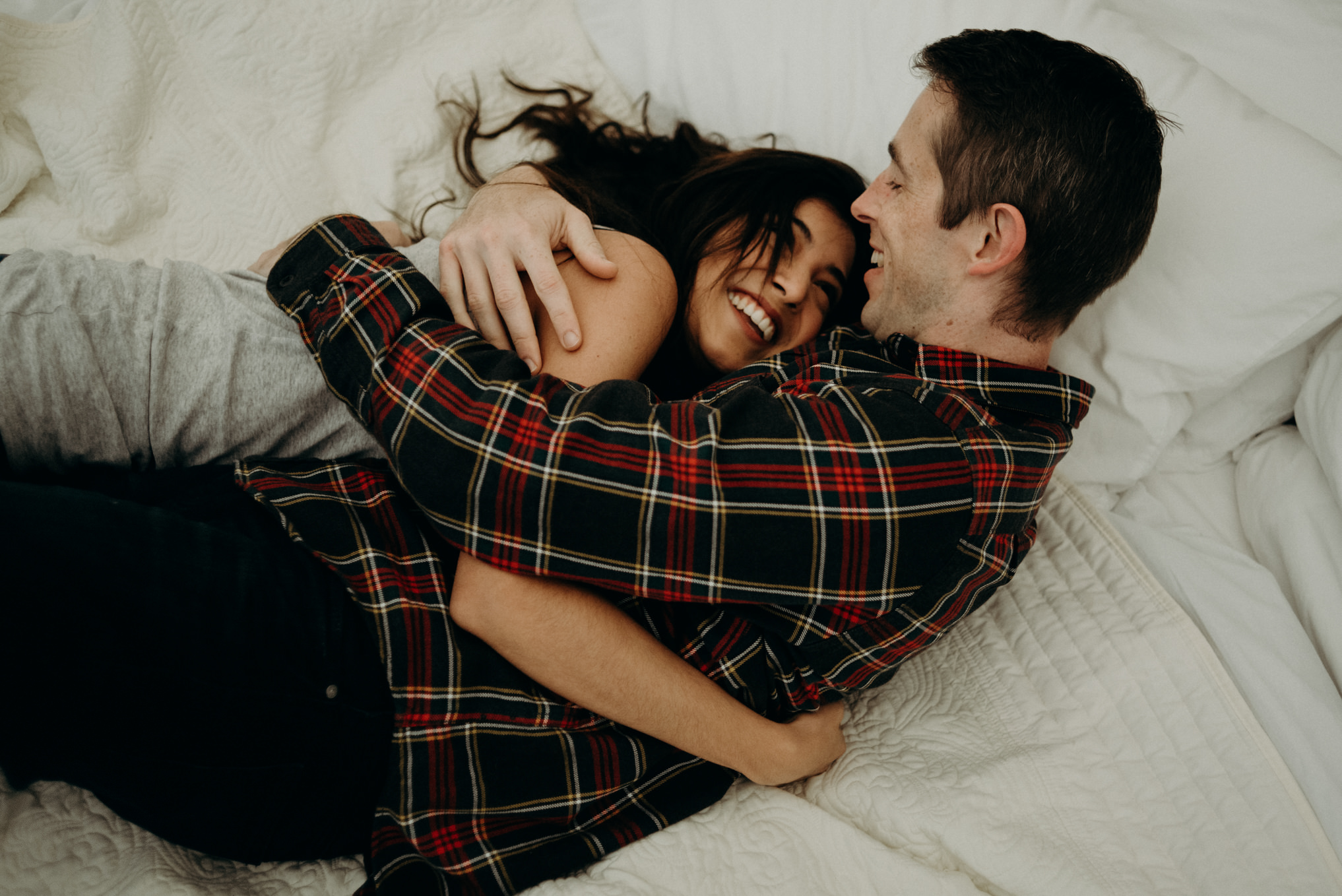 Couple cuddling on bed in glamping tent at Whispering Springs