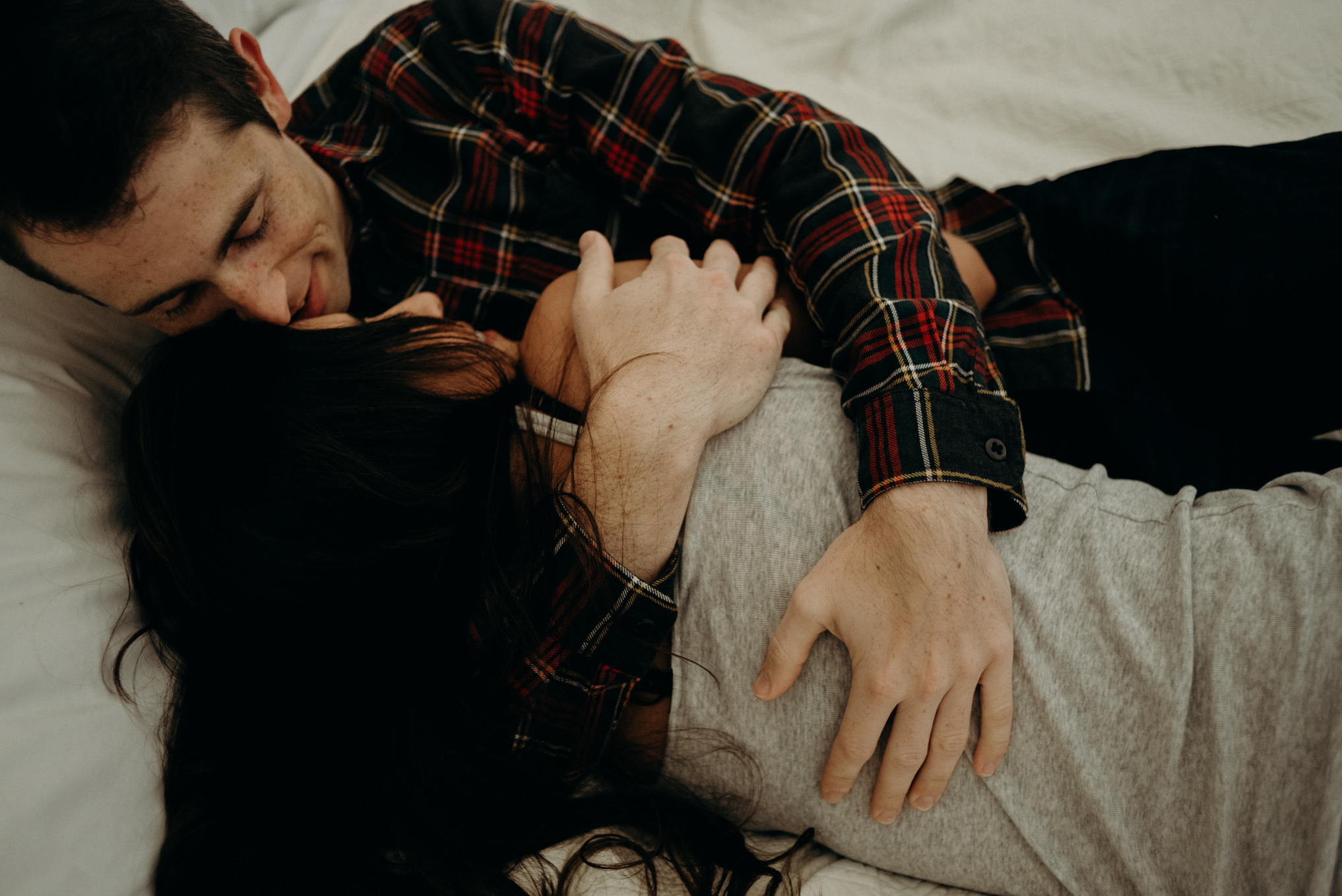 Couple cuddling on bed in glamping tent at Whispering Springs