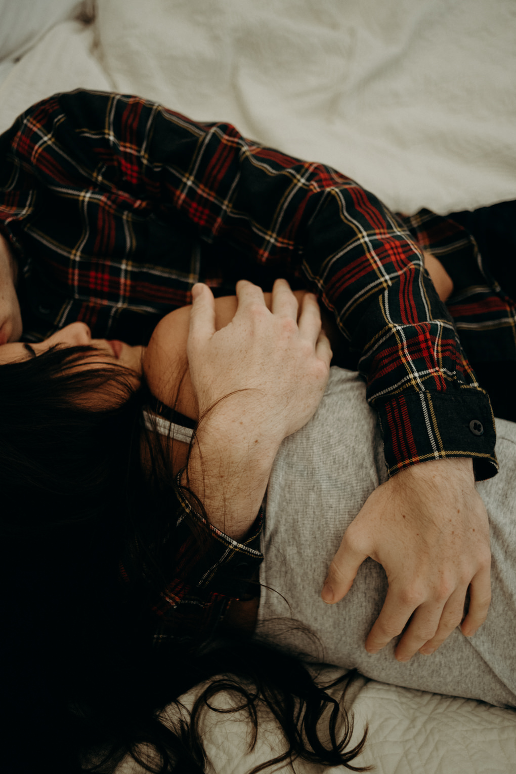 Couple cuddling on bed in glamping tent at Whispering Springs