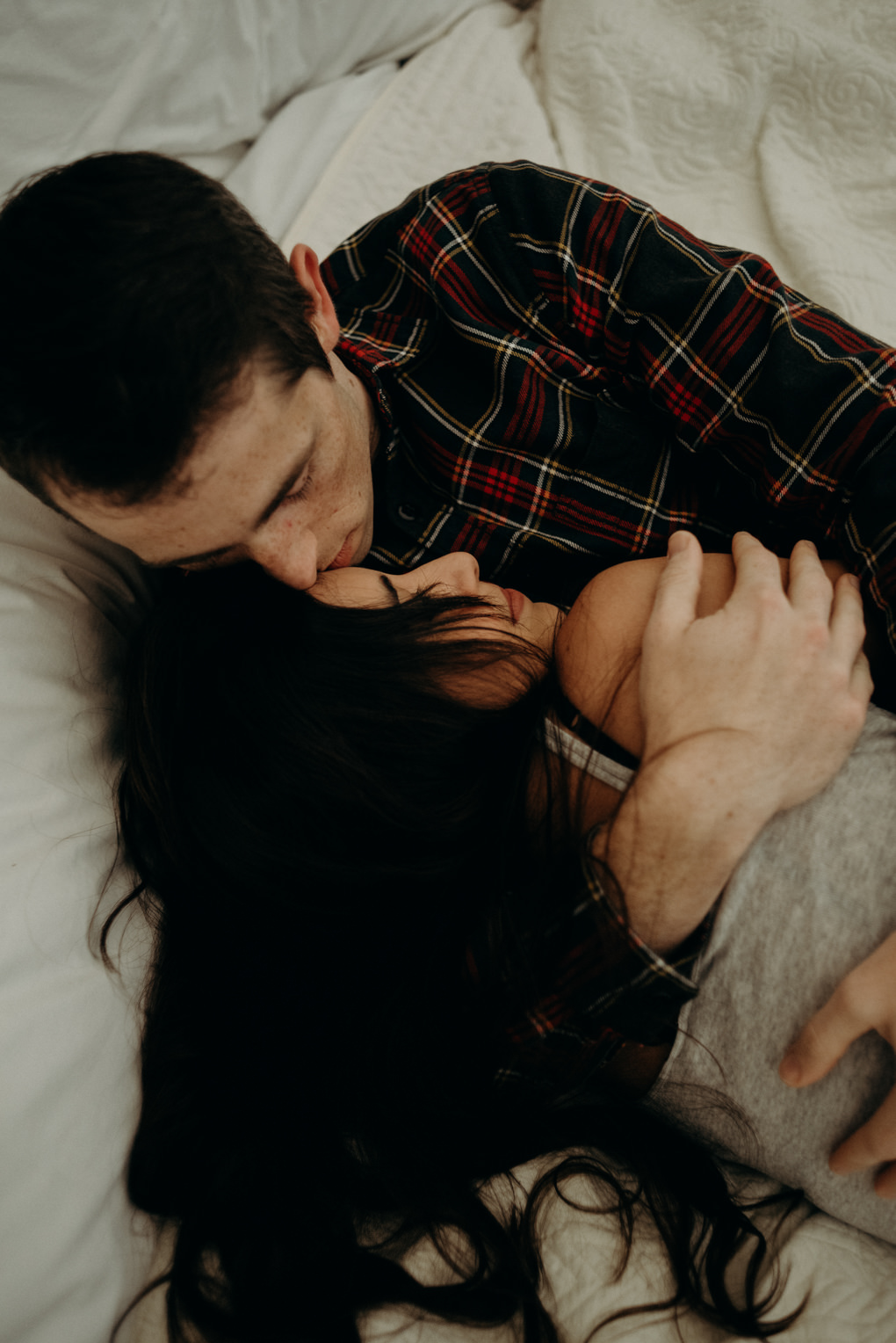 Couple cuddling on bed in glamping tent at Whispering Springs