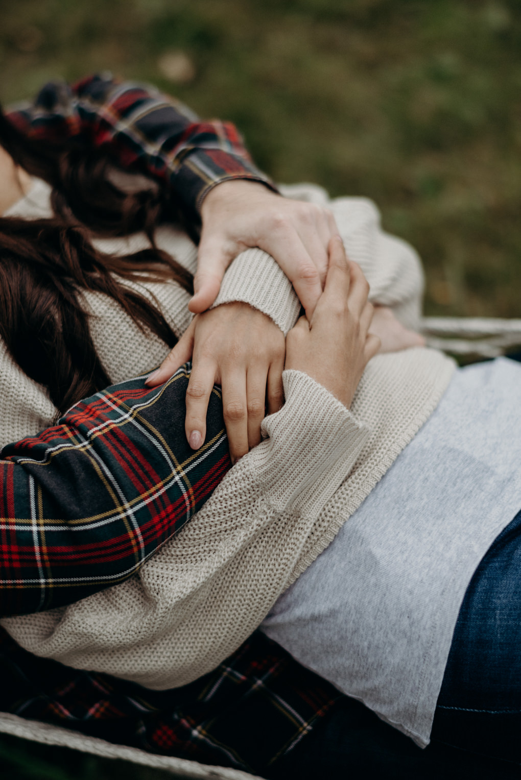 close up of couple cuddling in hammock