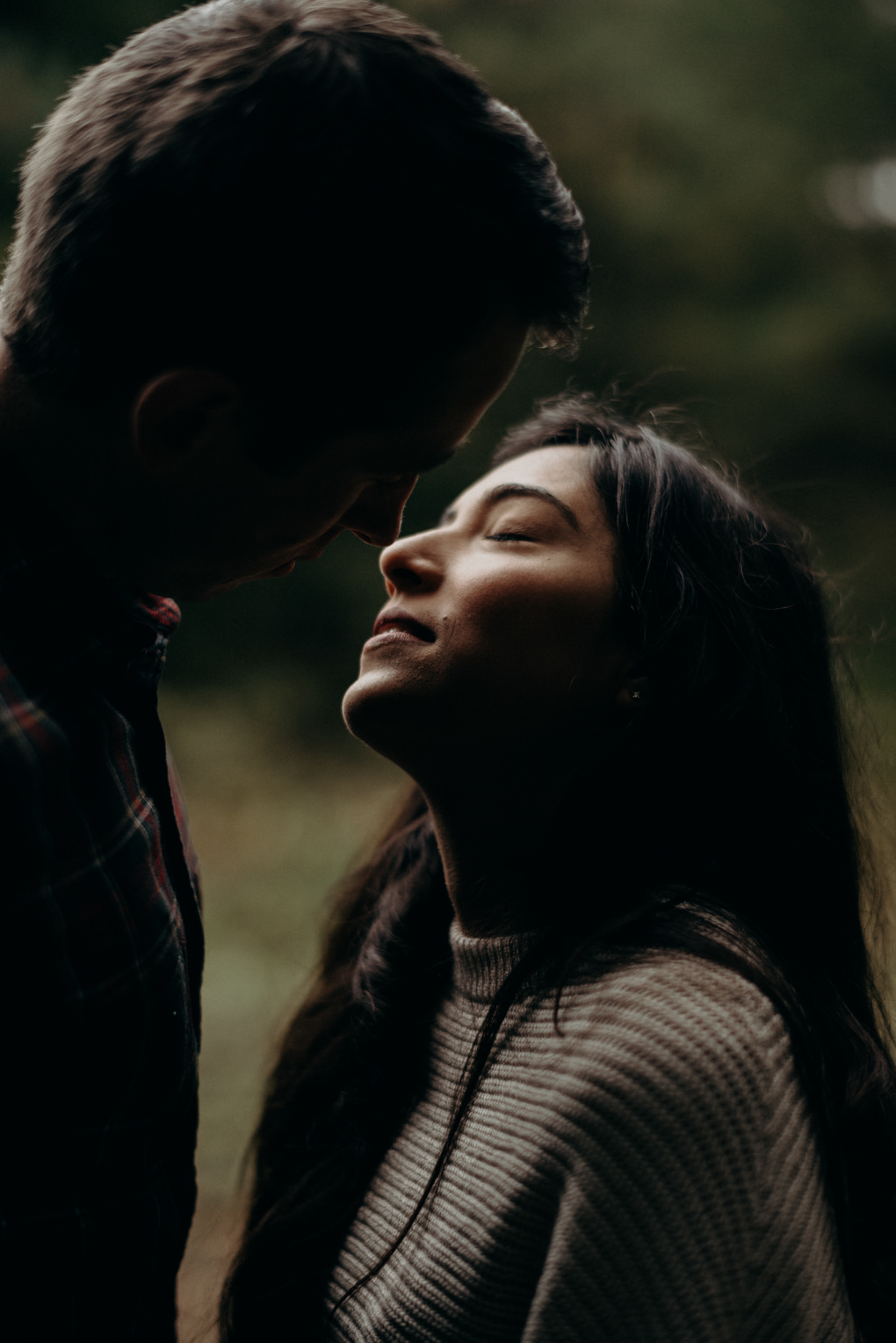 Couple sitting in a field, cuddling up