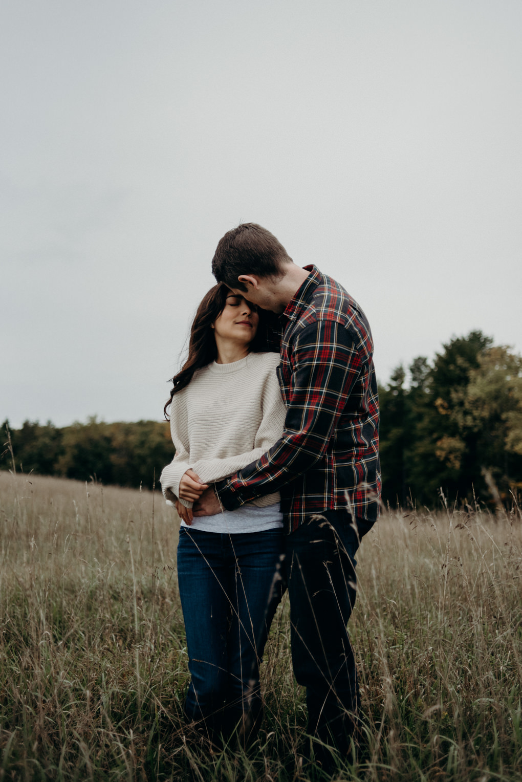 couple cuddling in the grass