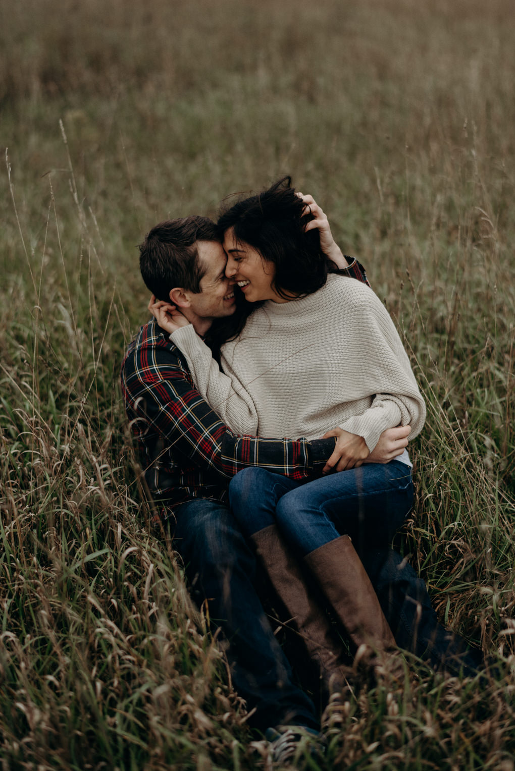 couple cuddling in the grass