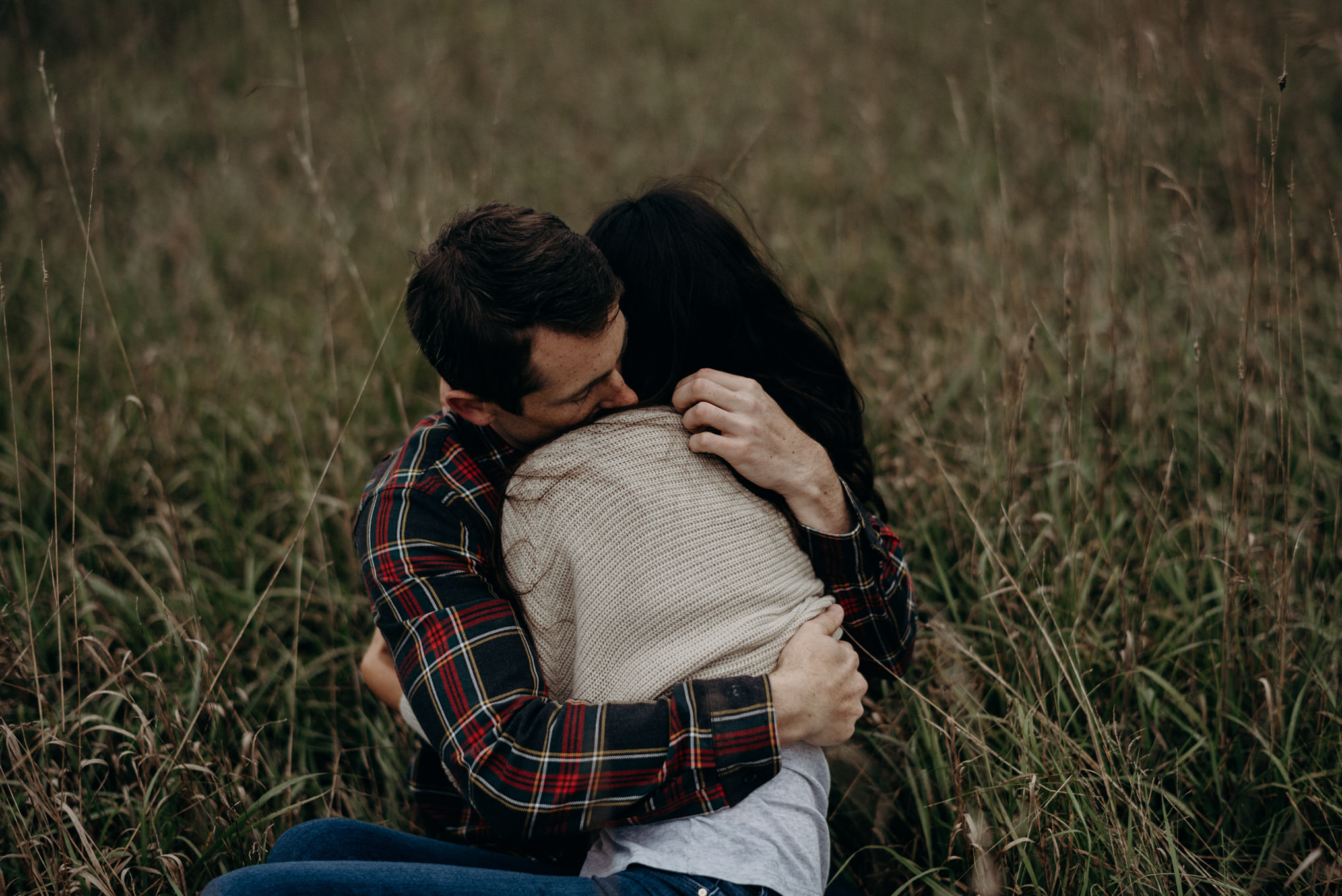 couple cuddling in the grass