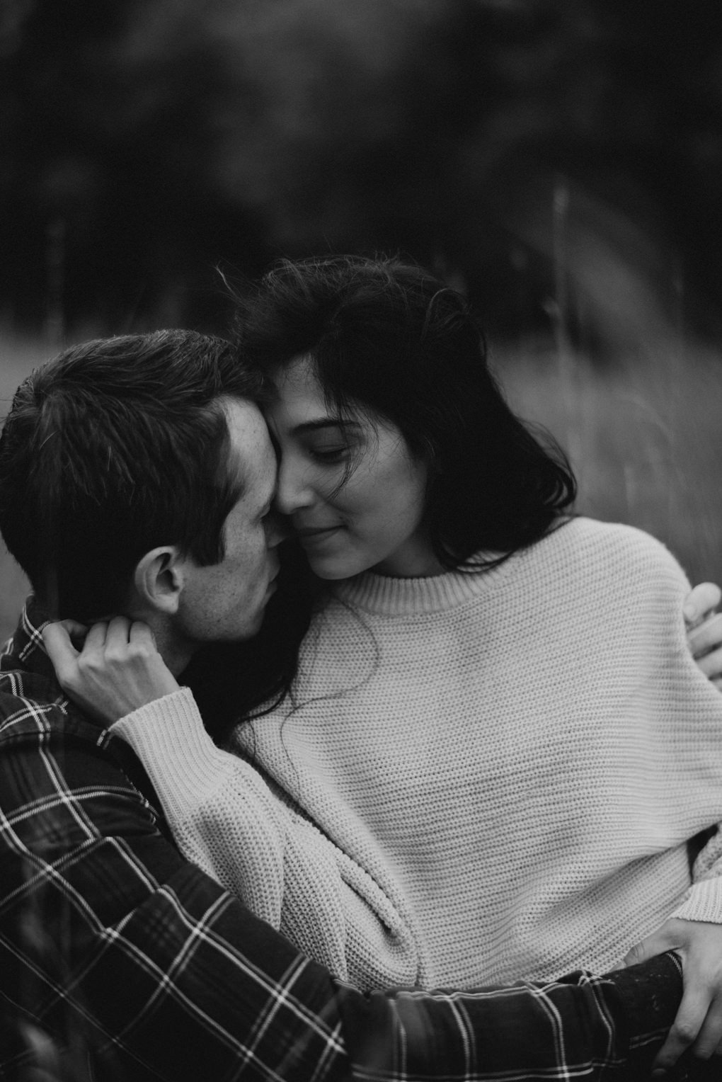 couple holding hands and walking in the grass at Whispering Springs