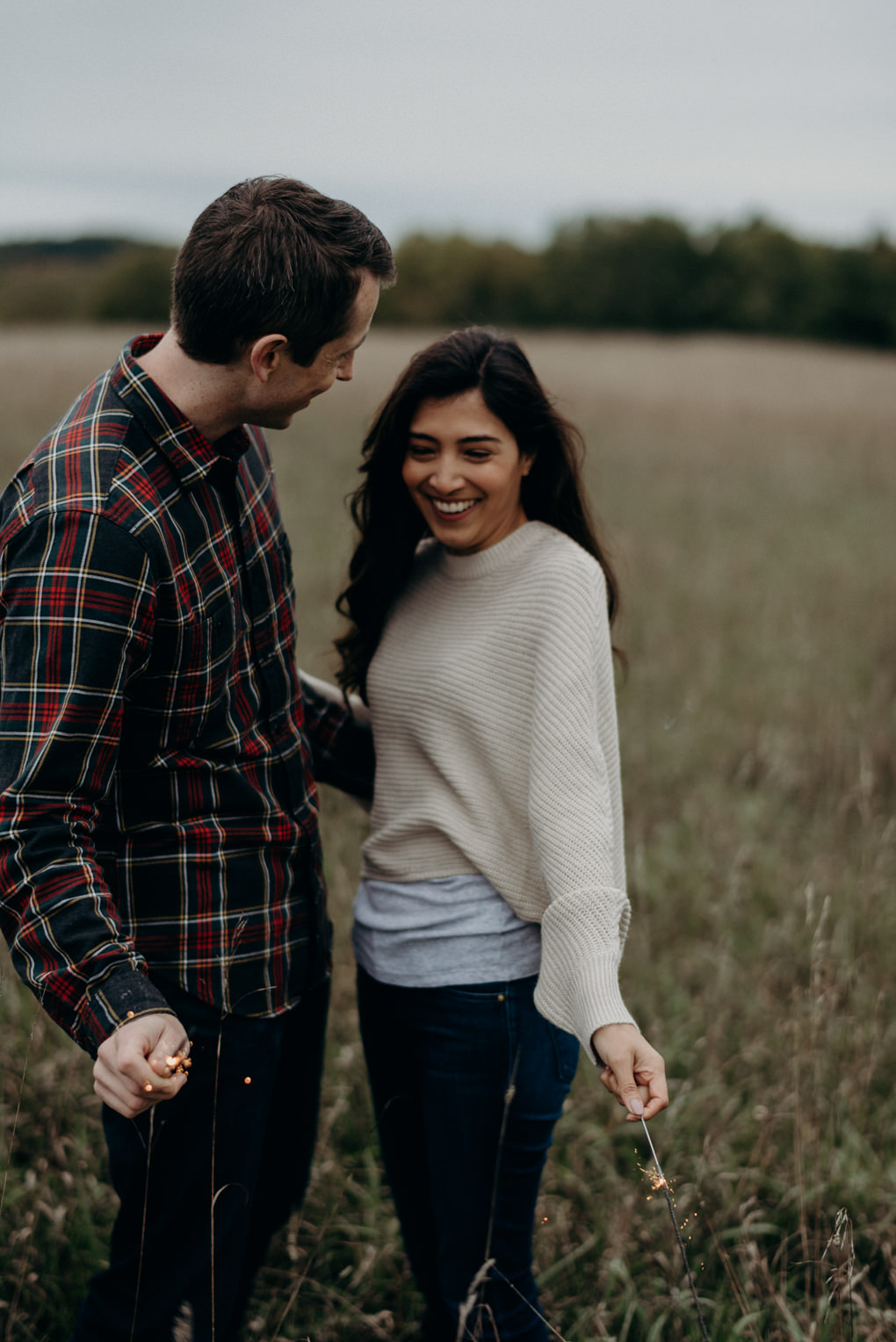 Couple walking on path out of forest