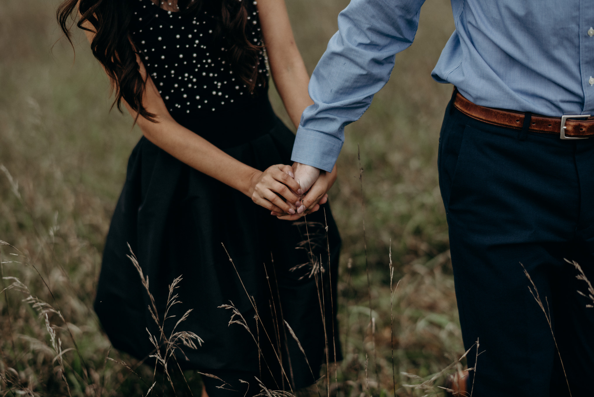 Couple with smoke bombs in a field