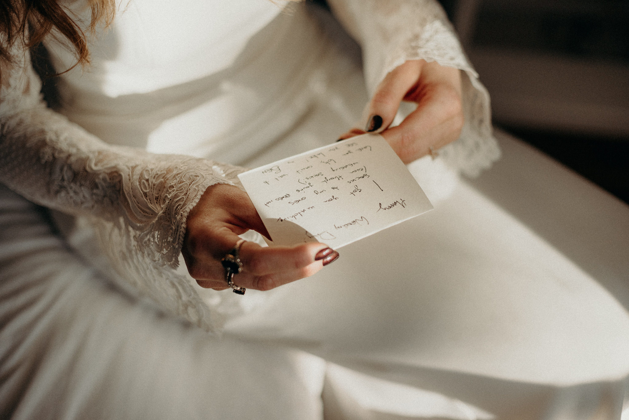 bride in wedding dress reading note from groom