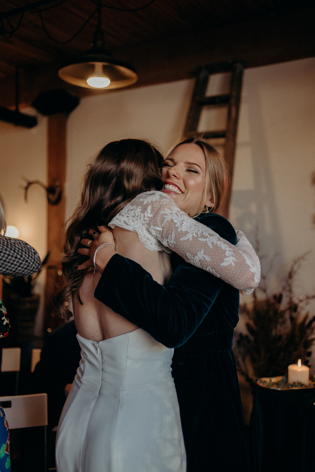 bride and groom laughing as guests toss confetti at them after the wedding ceremony in old loft in Toronto