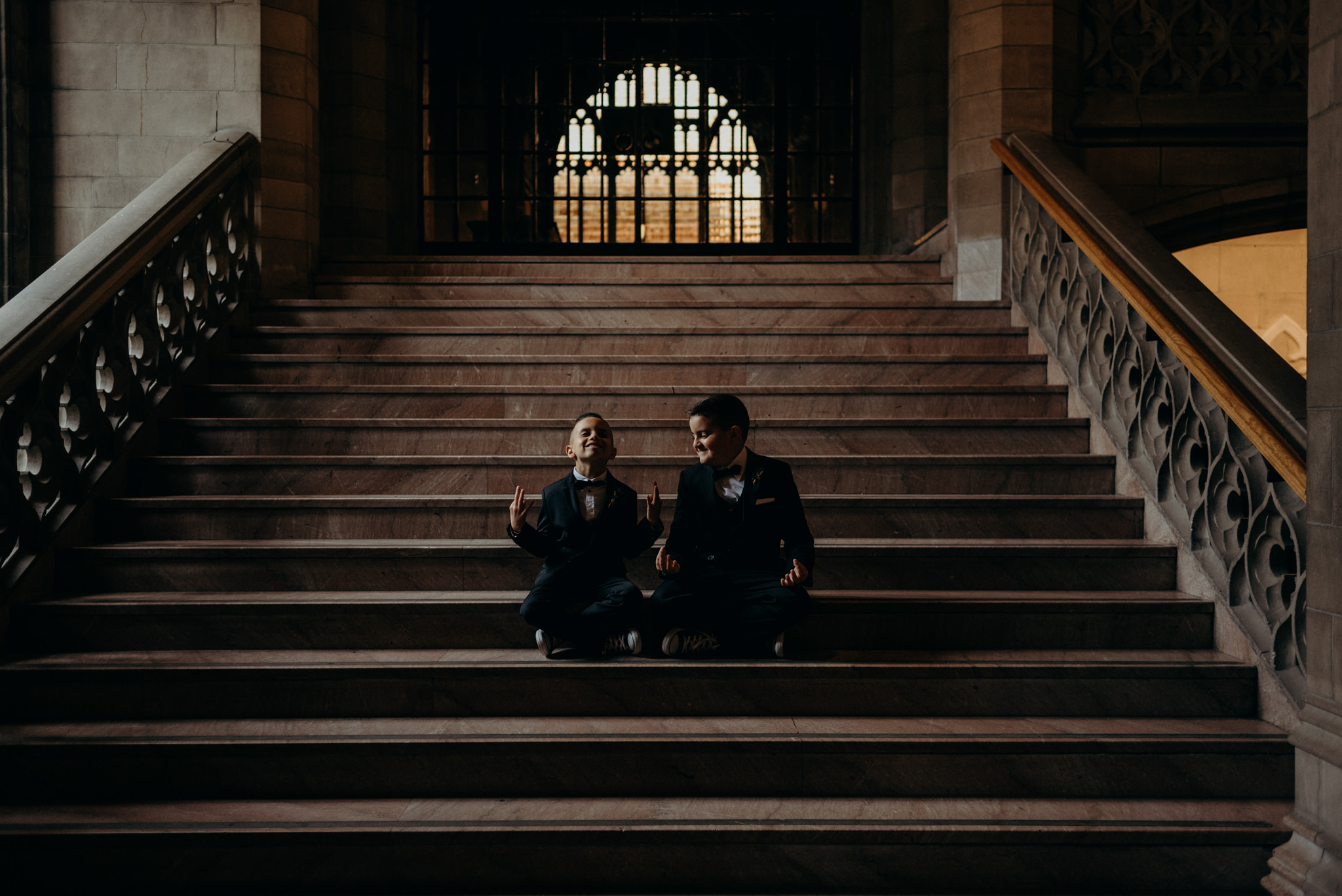 ringbearers sitting on steps inside Knox College