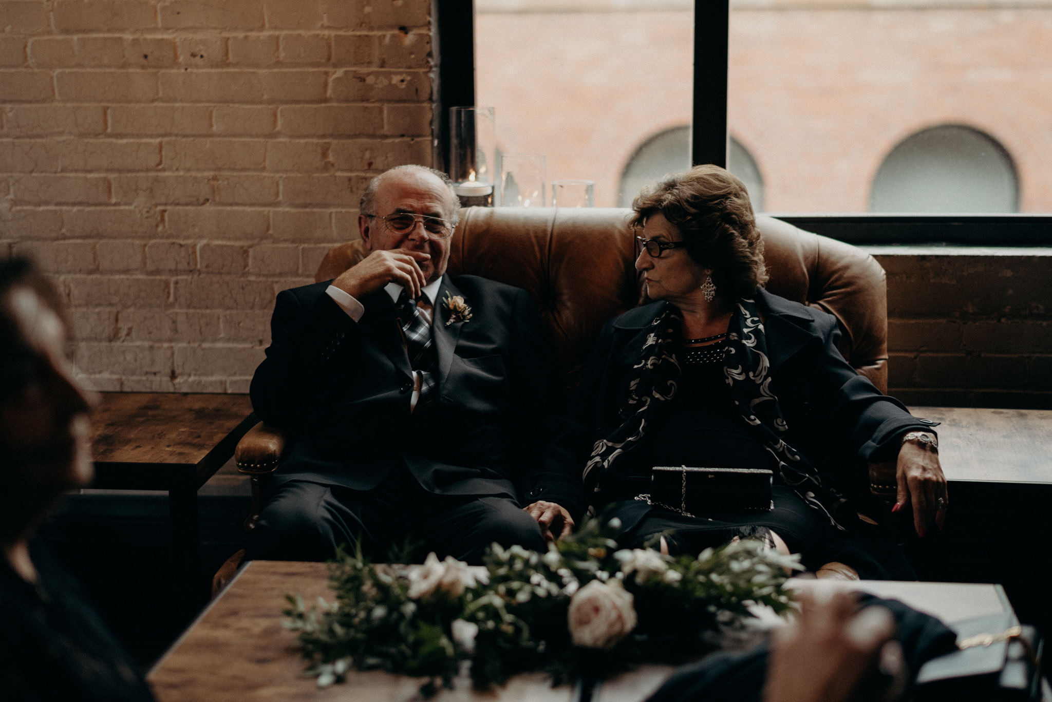 grandparents of bride sitting on couch during cocktail hour