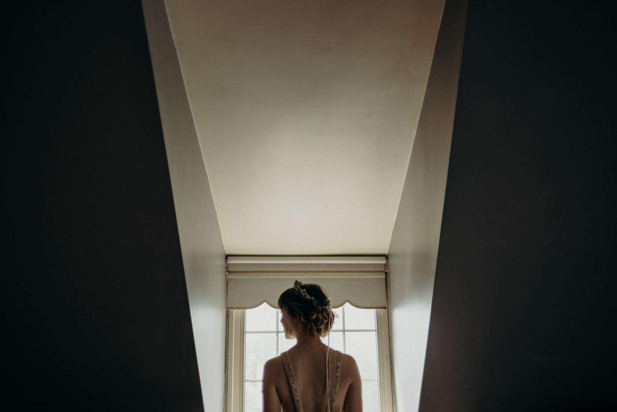 bride looking out window in loft