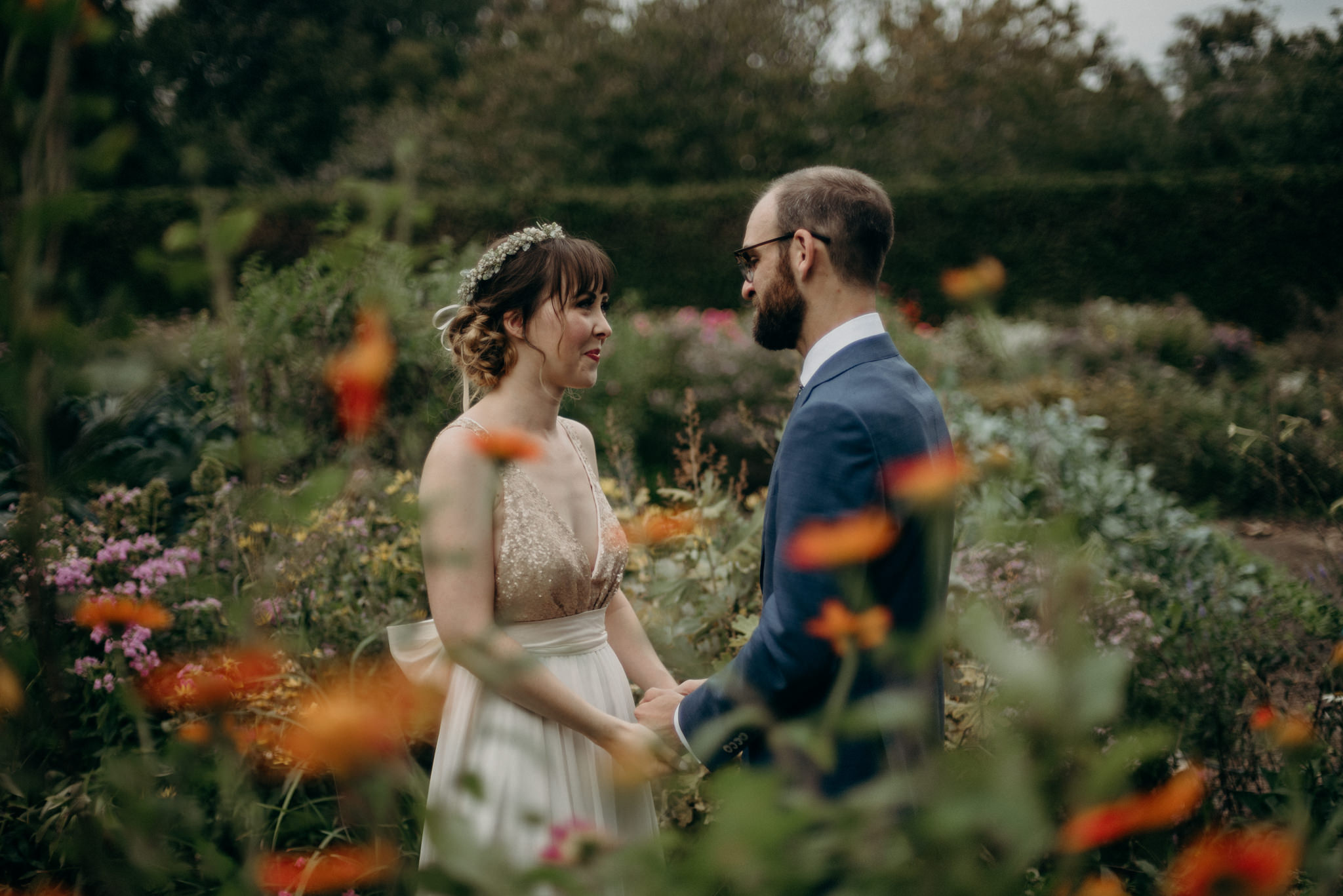 bride and groom holding hands and looking at each other in the gardens at Spadina Museum