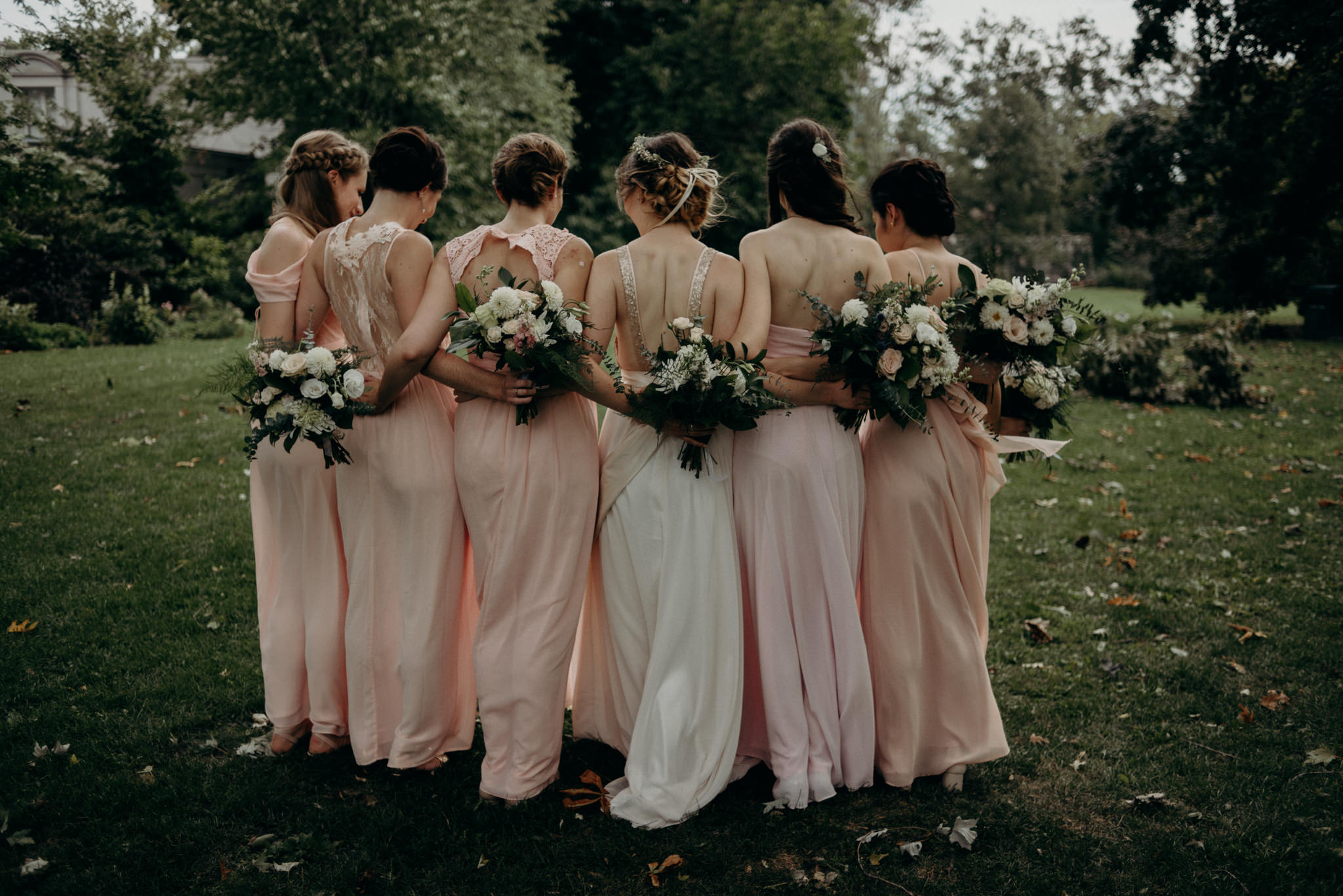 bridesmaids hugging outside